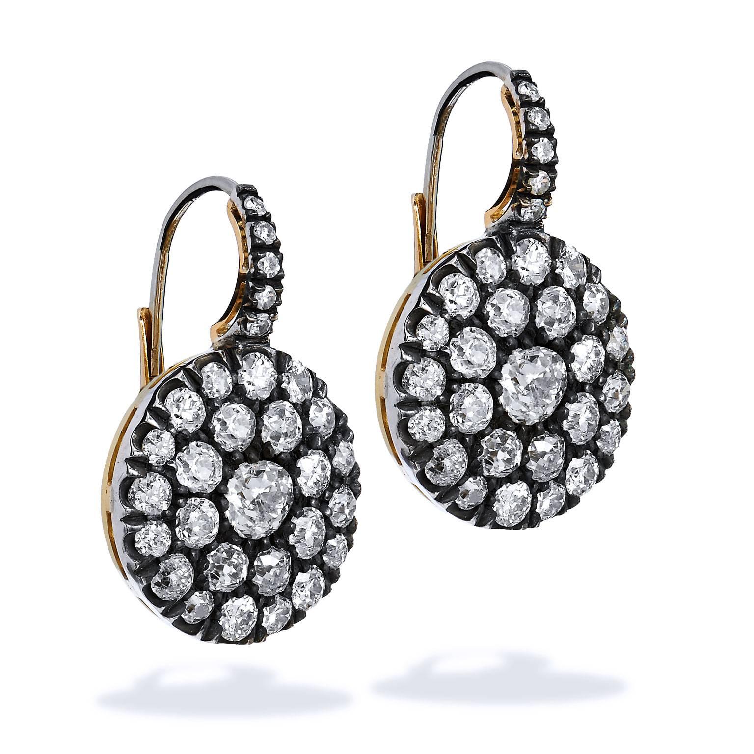 A pair of earrings whose charm and uniqueness glimmers with subtlety. An H and H original handmade design, these earrings feature sixty pieces of antique diamonds- resulting in a total weight of 4.61 carats of Old European, Old Mine and single cut