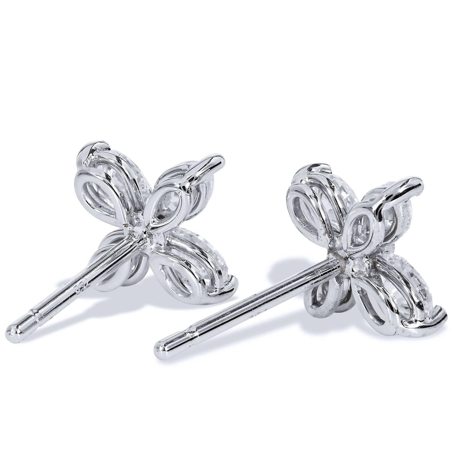 Eight pieces of marquise cut diamonds (total weight = 0.70 carat; F/G/VS2/SI1) with their lovely curving and fantastically oblong shape merge to form two flower-shaped 18 karat white gold and diamond stud earrings. Handcrafted by H and H, these