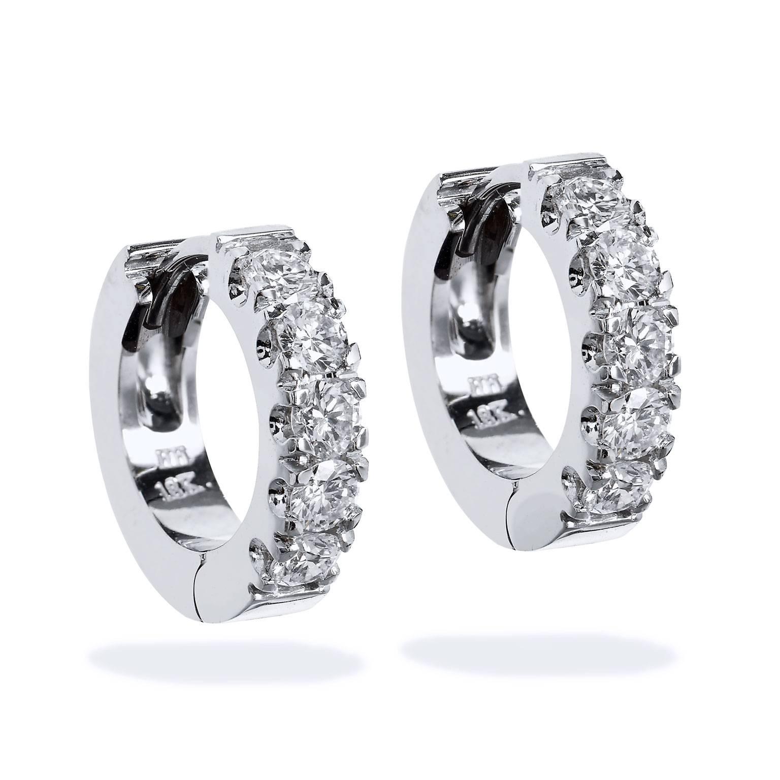 Mesmerizing in appearance, these handcrafted, H and H original 18 karat white gold huggie style hoop earrings feature 1.07 carat of diamond (H/VS2) in scalloped, shared prong setting- captivating from every angle.