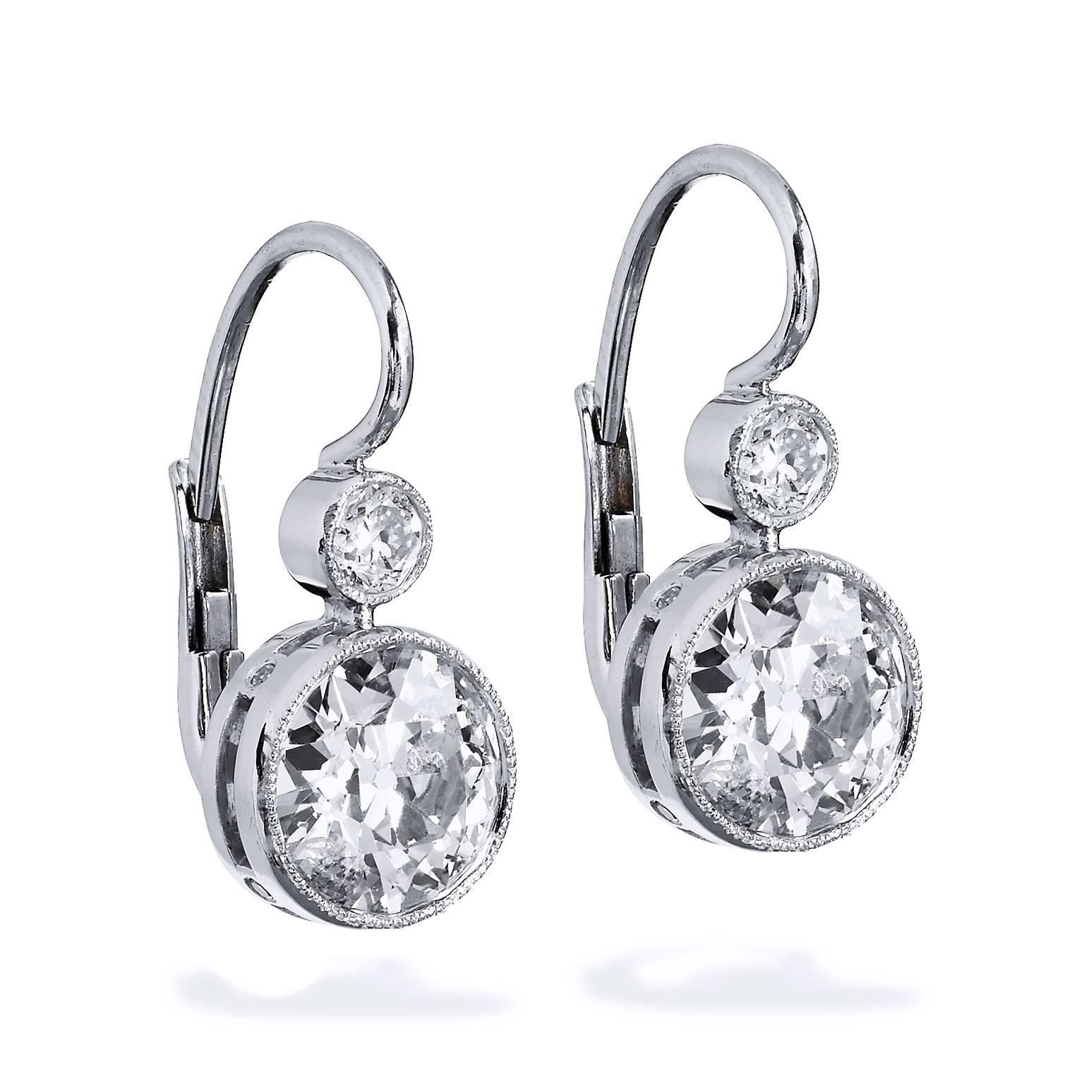 These are one of a kind and handmade by H&H Jewels.  They feature 2.90 carat Old European cut diamonds.
 
Both platinum and 18 karat white gold is used on these bezel set Old European cut diamonds.  
(1.54 carat, K/SI1;1.36 carat, J/I1). 

Two