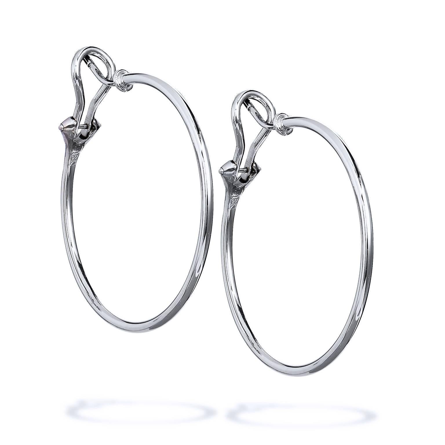 These handmade H and H 18 karat white gold hoop earrings are the casual and chic addition needed in one's wardrobe. Measuring 33 MM in diameter, these earrings are just the right size.