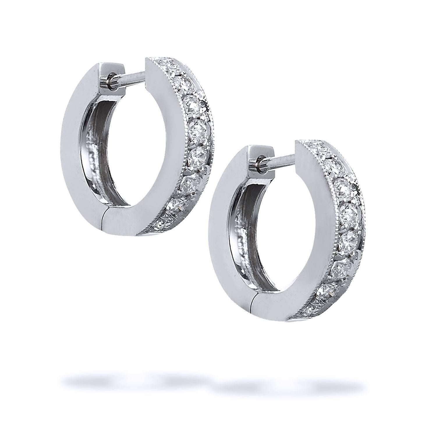 18 karat white gold act as a backdrop to a beautiful sea of 0.29 carat of diamond pave set with milgrain work (H/SI1) in these handmade H and H classic hinged hoop earrings. 


