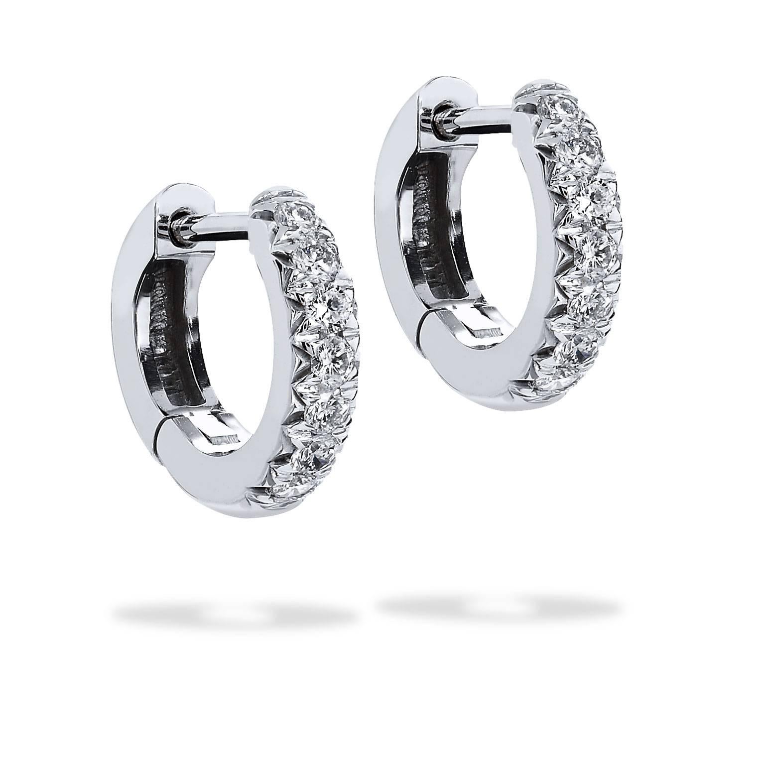 18 karat white gold acts as a backdrop to a beautiful sea of 0.23 carat of diamond pave set (G/H/VS) in these handmade H and H classic huggy hoop earrings measuring 11.30 mm.