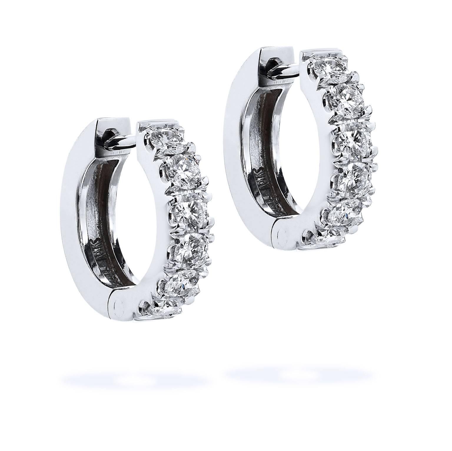 18 karat white gold acts as a backdrop to a beautiful sea of 0.50 carat of diamond prong set (F/G/VS2/SI1) in these handmade H and H classic huggy hoop earrings measuring 13 mm in diameter and 2.95 mm in width.