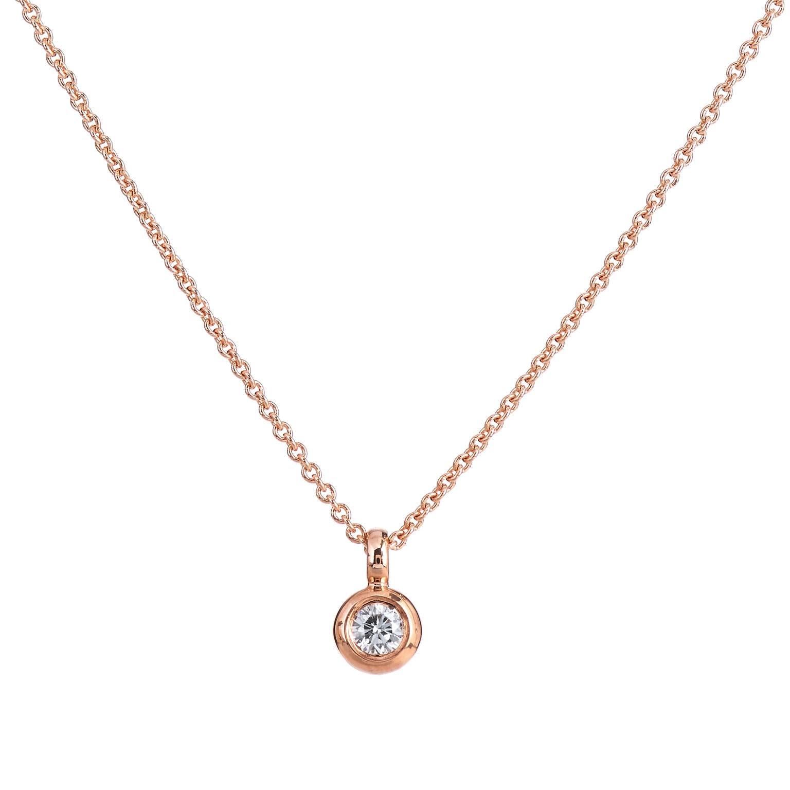 Fashioned in 14 karat rose gold, this pendant features a 0.07 carat round brilliant cut diamond set at center (E/F/SI) in bezel. Make this necklace a staple jewelry piece in your collection. Dress it up for a special occasion, layer it with multiple
