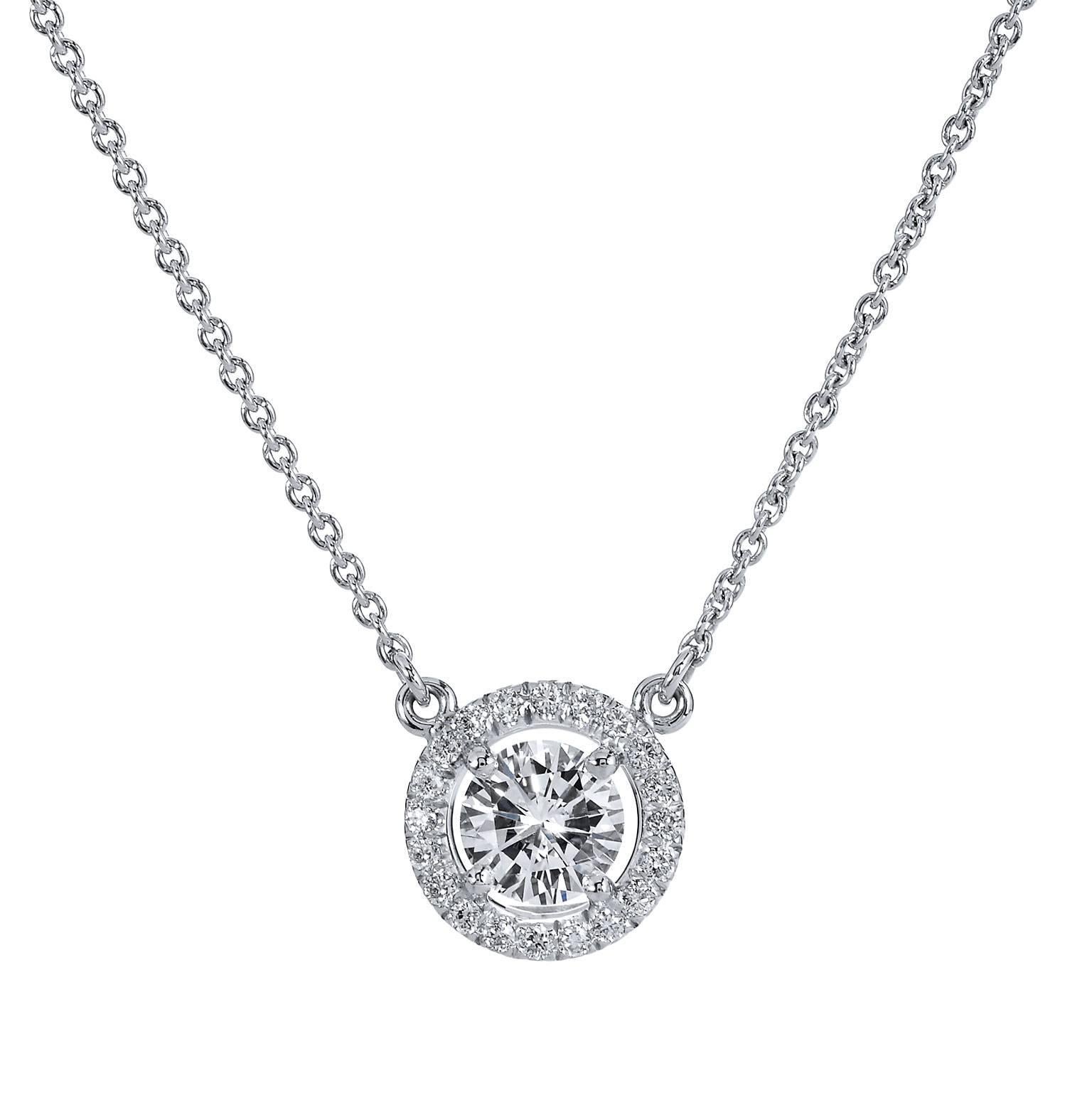 This H and H 18 karat white gold pendant necklace features 0.52 carat of round brilliant cut diamond bezel set and pave set at center (E/WS2; GIA#13217115). Simplicity and refinement reign supreme in this piece.