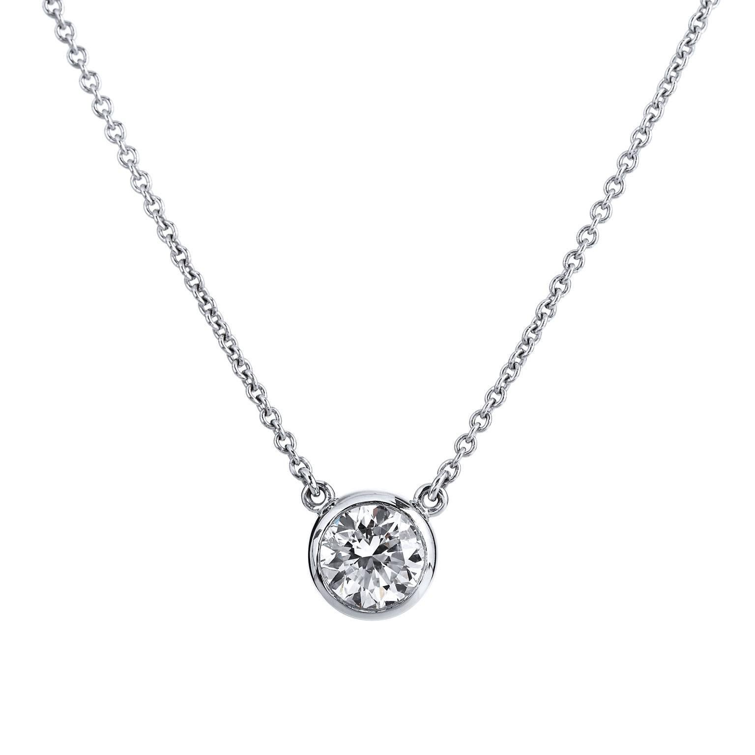 This H and H 18 karat white gold pendant features a lovely 1.01 carat round brilliant cut diamond at center bezel set (F/SI2; GIA#5171155033). Simplicity and refinement reign supreme in this piece.