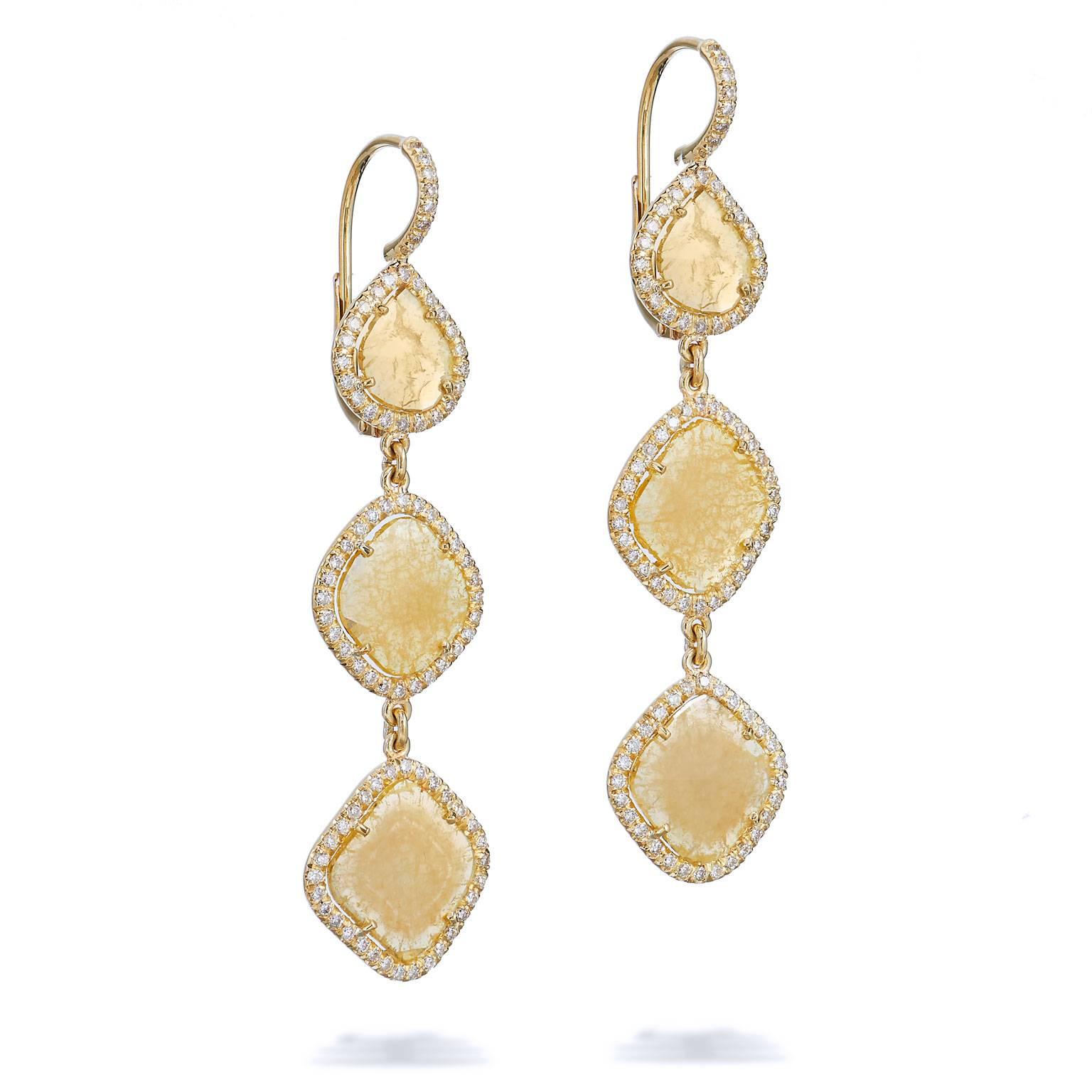 An original H and H design, these handcrafted 18 karat yellow gold multi-slice dangle earrings feature six fancy intense yellow diamond slices with a total weight of 4.39 carat. Slices provide an interesting presentation that allow the yellow