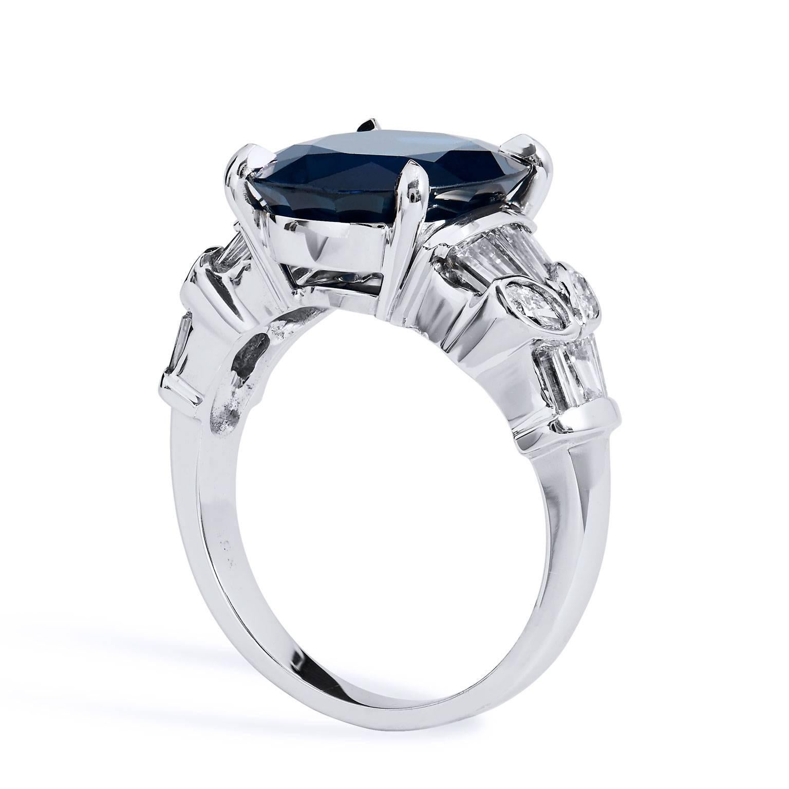 Reflect stately elegance with this blue sapphire, diamond and 18 karat white gold ring. A 7.44 carat oval blue sapphire is set at center (GIA #5172542810), while 1.50 carat of baquette and oval accent diamonds, arranged in a stylized and fanciful