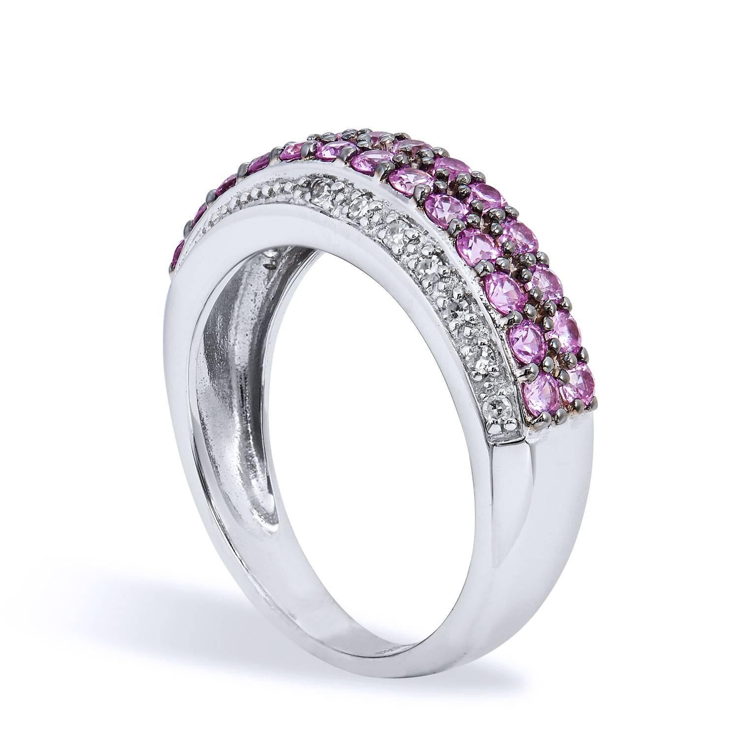 Enjoy this previously loved 14 karat white gold ring featuring fourteen single cut diamonds with a total weight of 0.10 carat and twenty-six pieces of pink sapphire pave set.