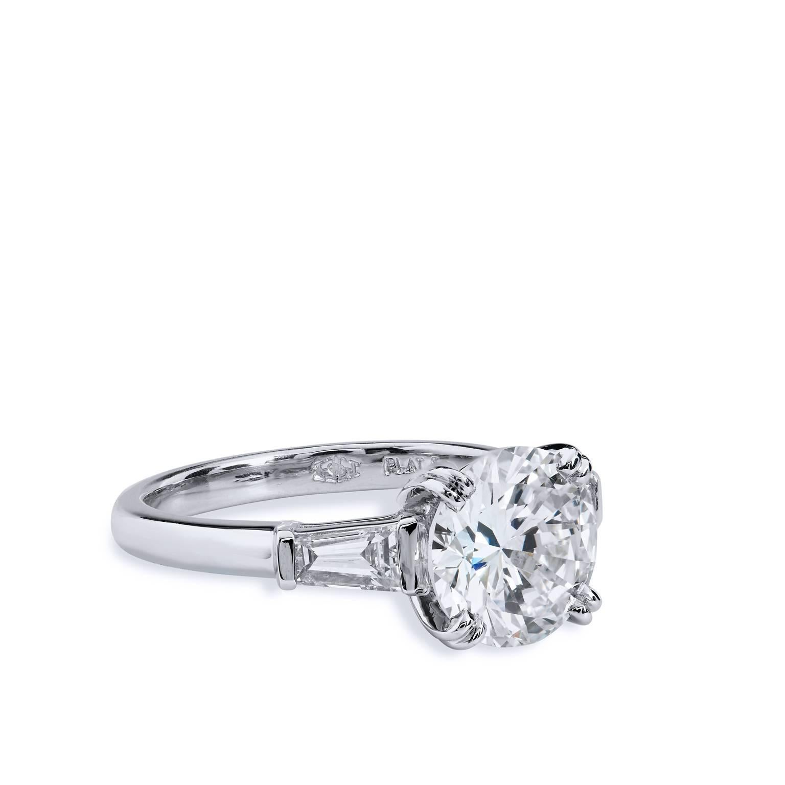 Leave her suspended in a dream with this beautiful H & H, handcrafted platinum and diamond engagement ring. Two tapered baguette diamond side stones weighing a total of 0.32 carat (J/K/VS)draw the eye toward the remarkable 2.22 carat diamond set at