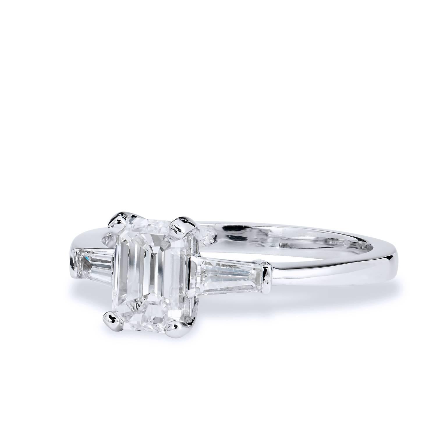 Handmade by H, this platinum engagement ring features a 1.13 carat emerald cut diamond set at center (GIA#2151727348). Two baguette diamonds, with a total weight of 0.30 carat (J/K) set at both sides of the shank, further enhance this piece. An