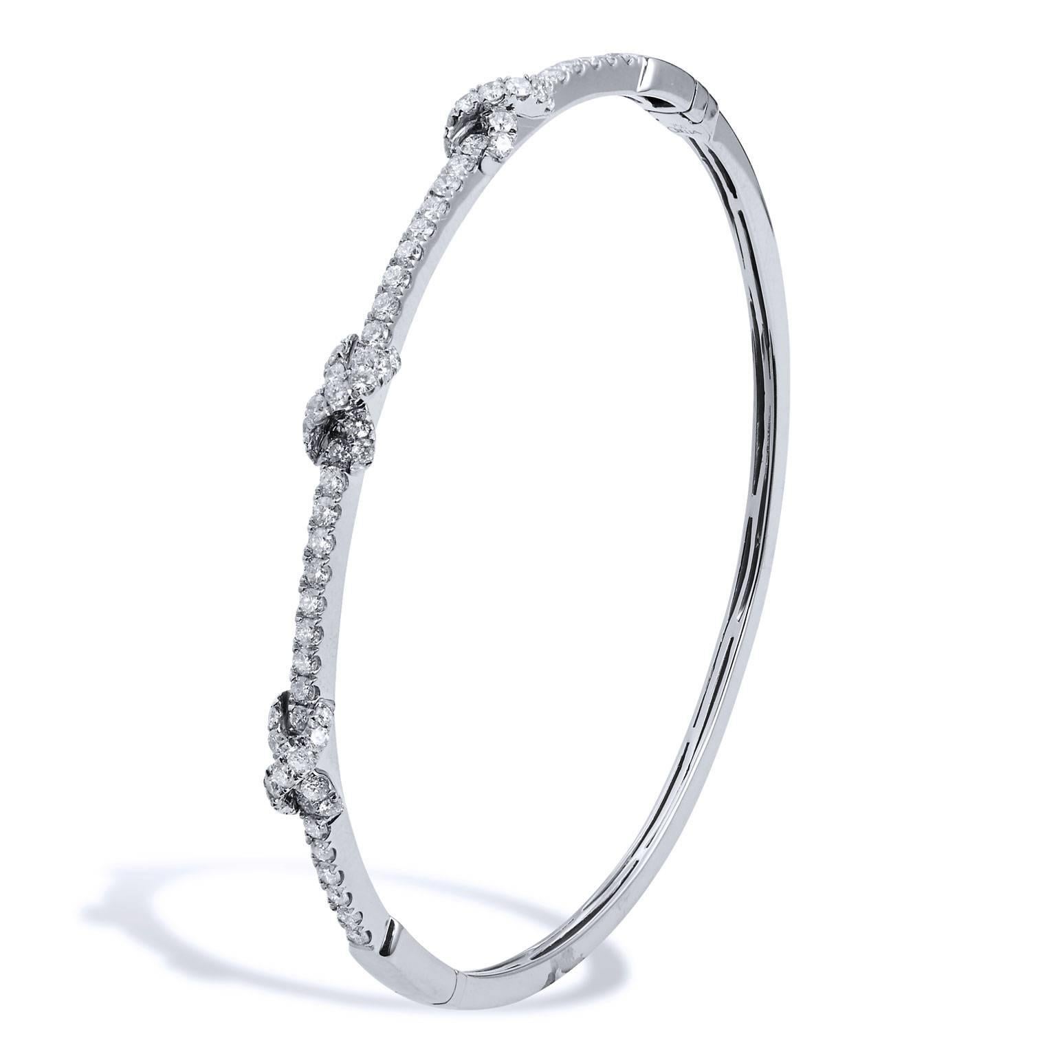 This oval bangle is fashioned in 18 karat white gold and features 1.26 carat of  pave-set diamonds which embellish three knot-shapes (G/H/VS).