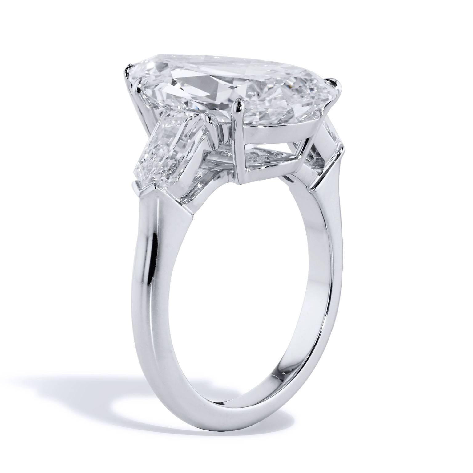There are no words to match the exquisiteness of this diamond engagement ring. Set in platinum and featuring a massive and impeccable 7.01 carat pear-shaped diamond (H/VS2; GIA# 1176082015) at center, two bullet-shaped accent diamonds with a total