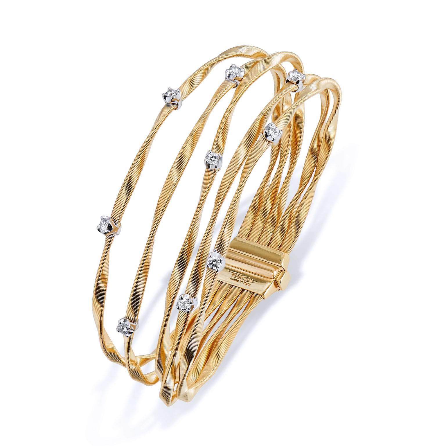 Enjoy this previously loved Marrakech Five Strand 18 karat yellow gold bracelet. Featuring Marco Bicego's exclusive coiled gold strands accented with nine brilliant cut diamonds (approximately 0.45 carat) set in a contrasting white gold setting