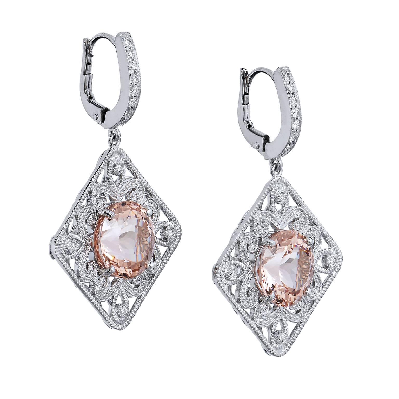 Revel in the joy of morganite and diamonds in these handmade H and H drop lever-back 18 karat white gold earrings. Two prong-set morganites, with a total weight of 10.03 carat, are positioned at center- bursting with luscious elegance. Decorative