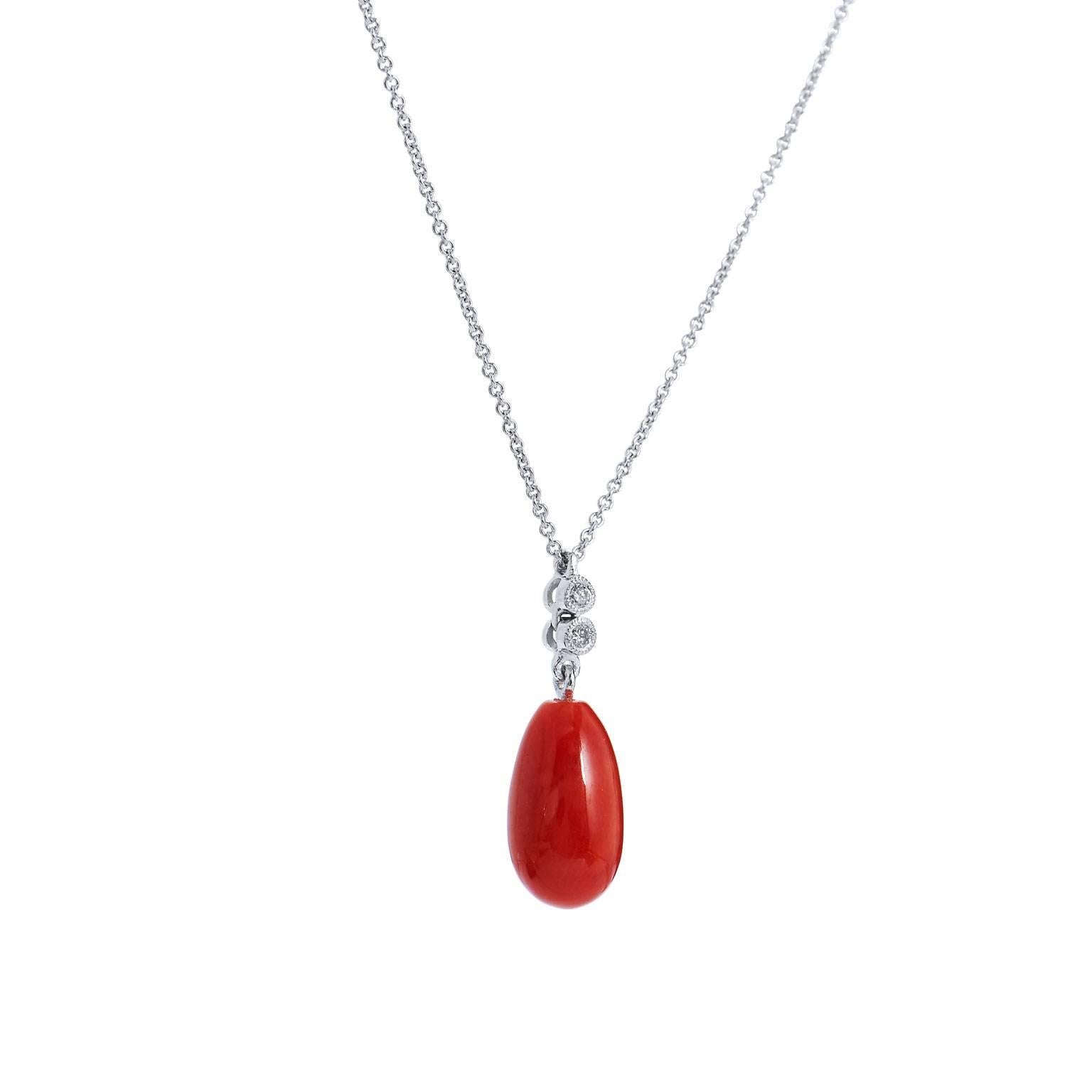 Like a teardrop falling from the sun, red coral burns with intensity in this handmade H and H drop pendant. Featuring 0.02 carat of bezel set diamond at the bail, this 18 karat white gold drop pendant is absolutely sublime.