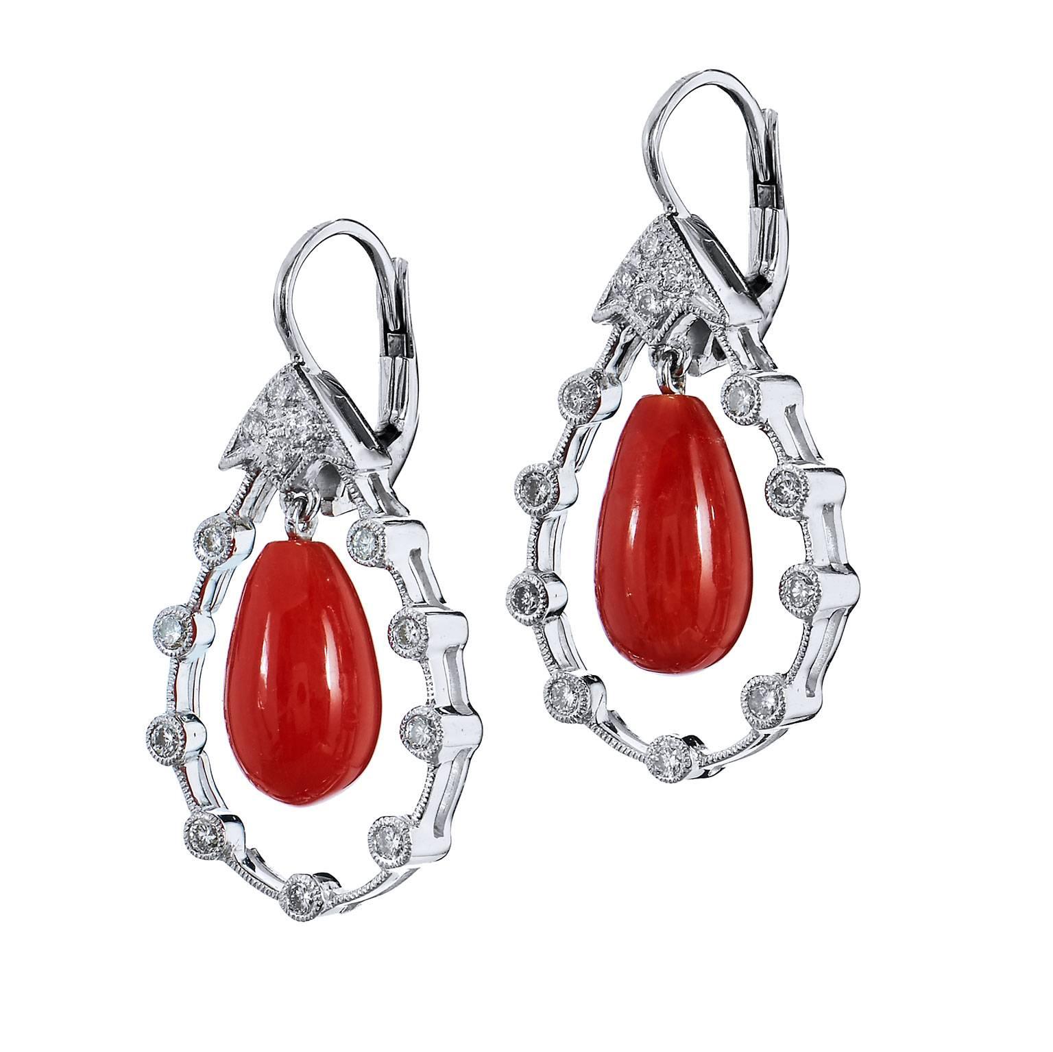 Like rays of the sun peering through the screen of the clouds, red coral burns with intensity in these previously loved 18 karat white gold drop earrings. Featuring 0.35 carat of bezel set diamond (I/J/K/SI1) arranged in an ornate fashion.
