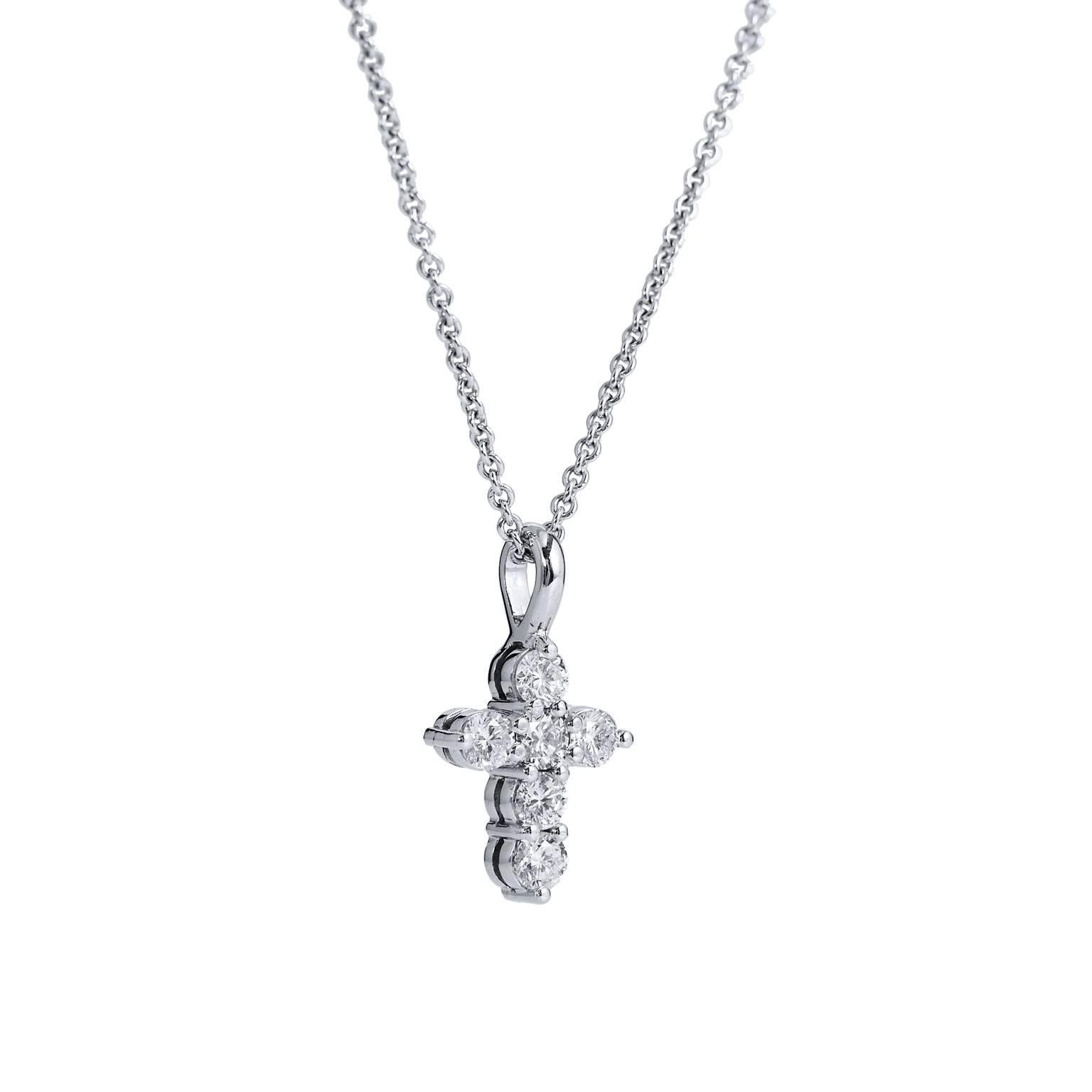 This handmade H and H cross pendant fashioned in 18 karat white gold features 0.59 carat of prong-set round brilliant cut diamonds (H/I/SI1). The timeless design will be your signature piece for decades to come (only the pendant reflected in price).