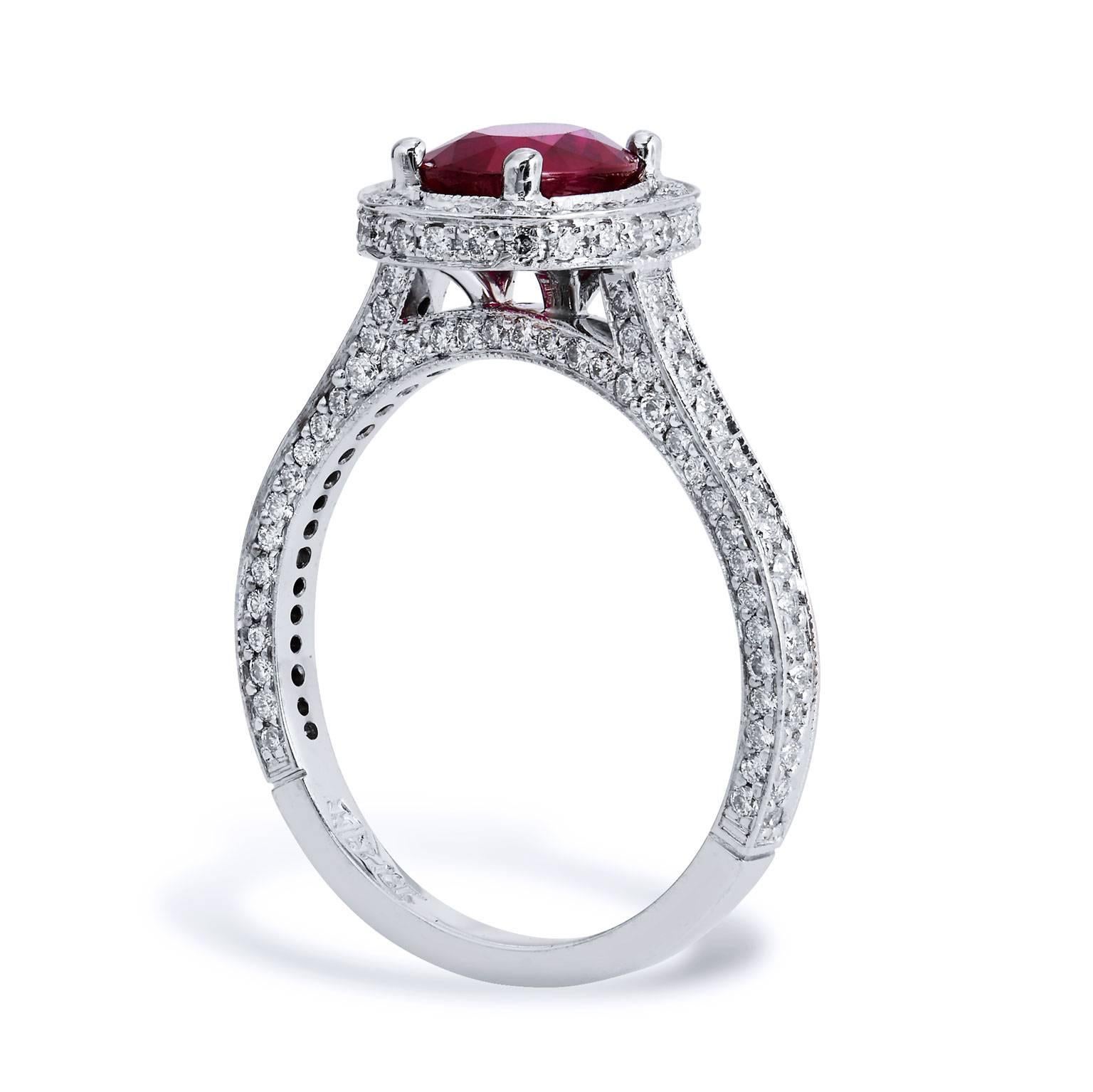 Enjoy this previously loved 18 karat white gold fashion ring featuring a 1.38 carat oval Burma  Ruby set at center (GIA #6157644841) 0.82 carat of pave set diamond encircle the ruby and cascade down the shank.

