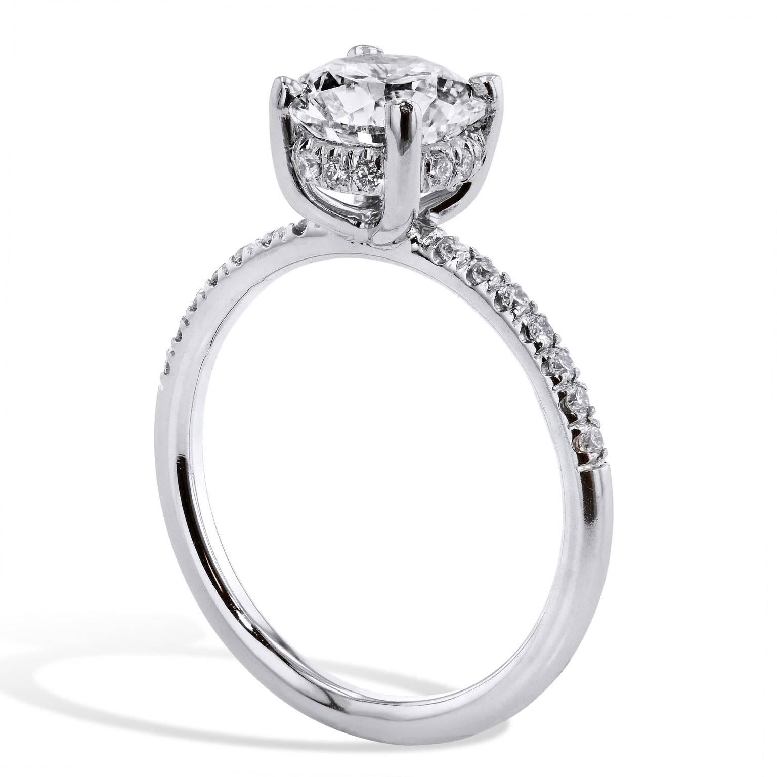 Breathtaking natural beauty defines this handmade engagement ring. Handmade in platinum by H, this ring features a 1.50 carat GIA certified round brilliant cut prong set diamond graded J/VS1 (GIA#1136496231). The solitaire engagement ring is one of