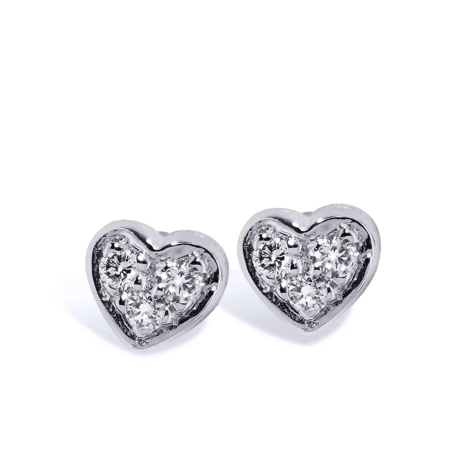 Simple and sweet, 0.05 carat of pave set diamond (G/H/VS2/SI1) are fashioned in the shape of a heart in these handmade 14 karat white gold stud
earrings. Let a little bit of your love shine through with this pair of earrings.
