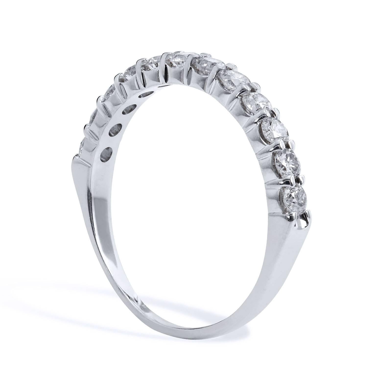 Twelve round diamonds (K/L/SI2), with a total weight of 0.42 carat, are affixed to a 14 karat white gold shared-prong shank in this previously loved band ring. This ring is simply lovely.
