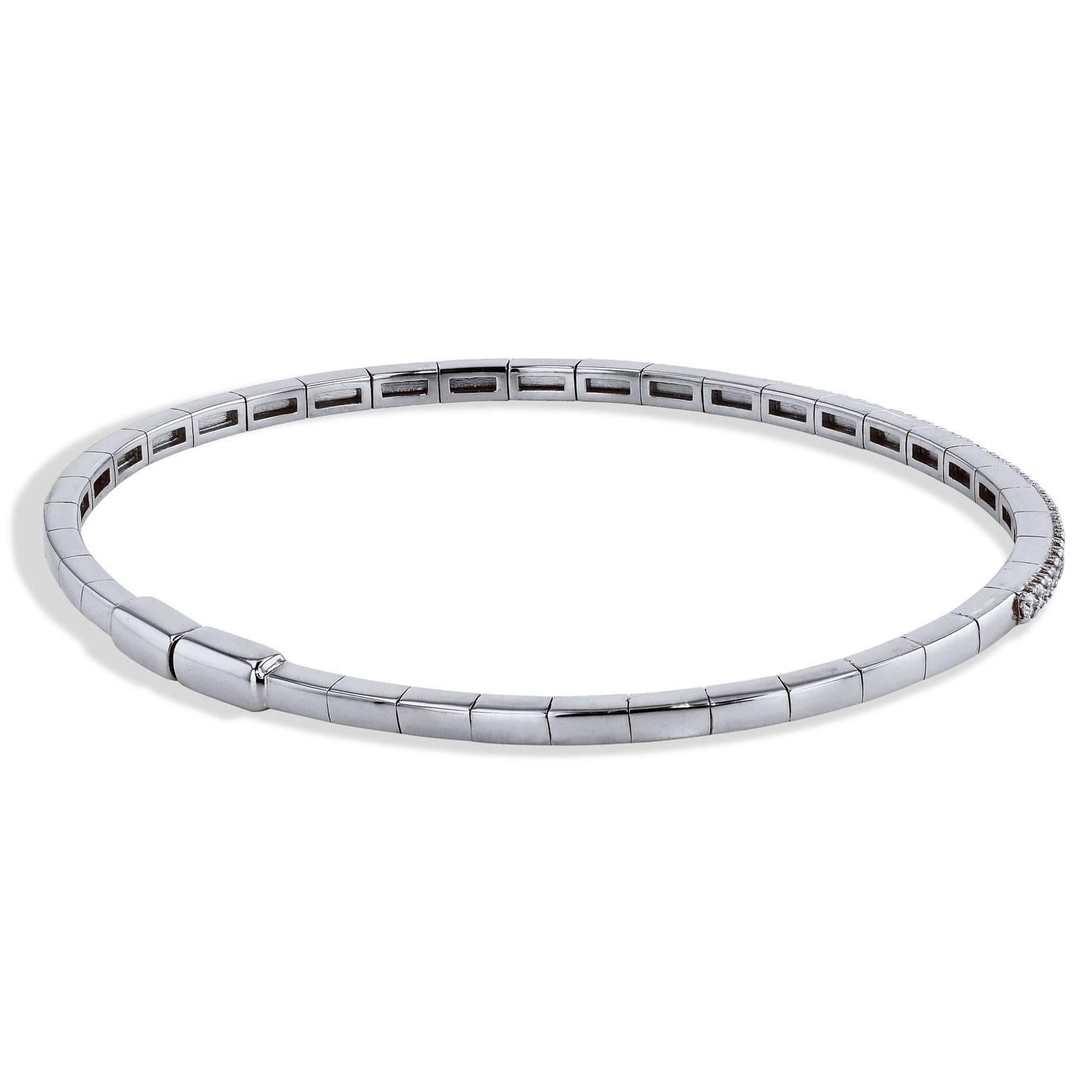 0.59 carat of pave-set diamond are affixed in 18 karat white gold in this magnetic bangle.