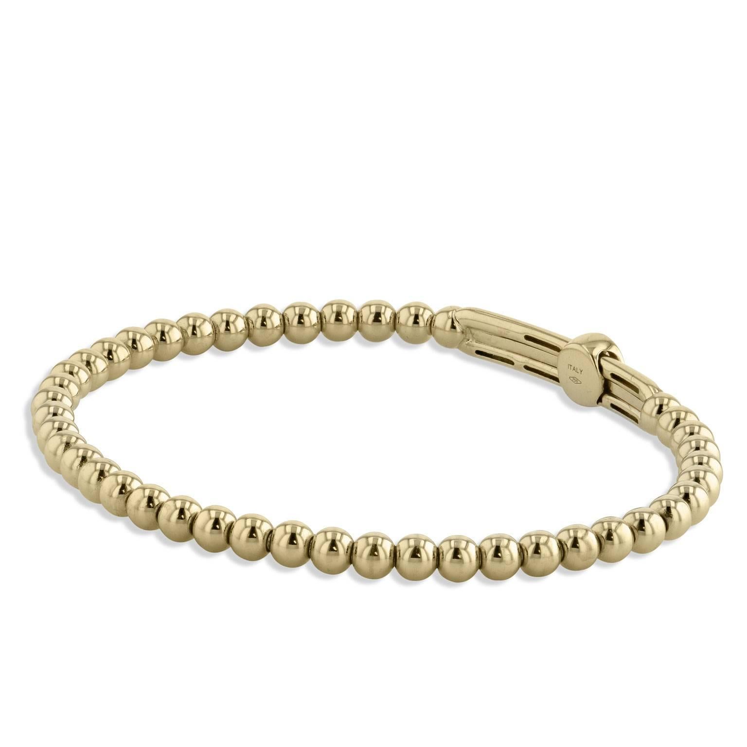 0.22 carat of pave-set diamonds are affixed within a bar on a disc slide in this 18 karat yellow gold beaded bracelet.