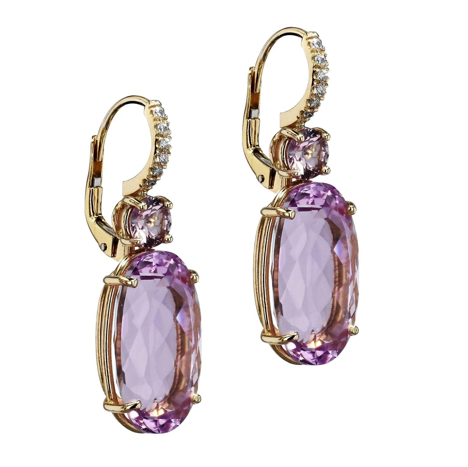 Feminine, sensual and soft, these handmade kunzite and pink sapphire lever-back earrings exemplify all that a woman desires in the perfect gift. Fashioned in 18 karat yellow gold, 21.90 carat of oval-shaped kunzite is set below as 1.08 carat of pink