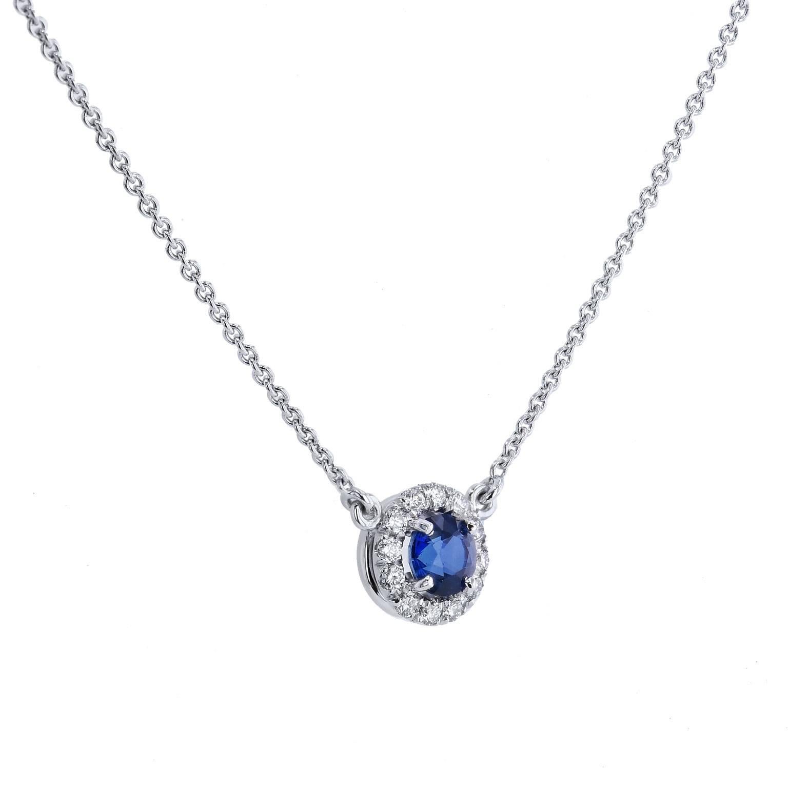 Let the sapphire’s tranquil blue hue sweep you away in this handcrafted 18 karat white gold pendant necklace. A 0.49 carat royal blue sapphire is set at center and embraced by 0.12 carat of pave set diamond in halo (F/G/SI1). Strung on an 18 kart