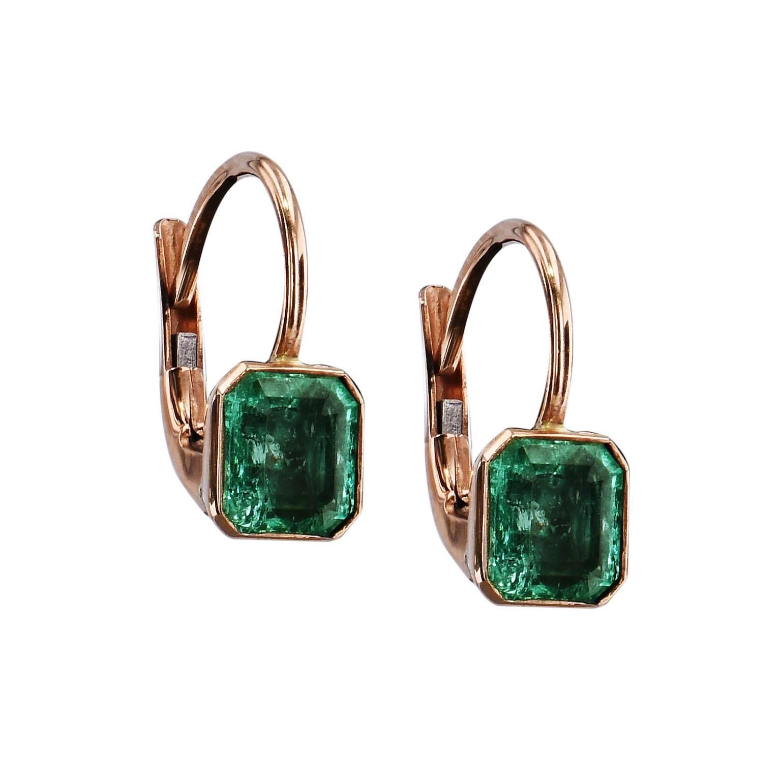 18 karat rose gold bezel-set 1.35 carat Colombian emeralds draw the eye in and chases one's gaze down each step of the emerald cuts. These handmade lever-back earrings wont easily be forgotten.