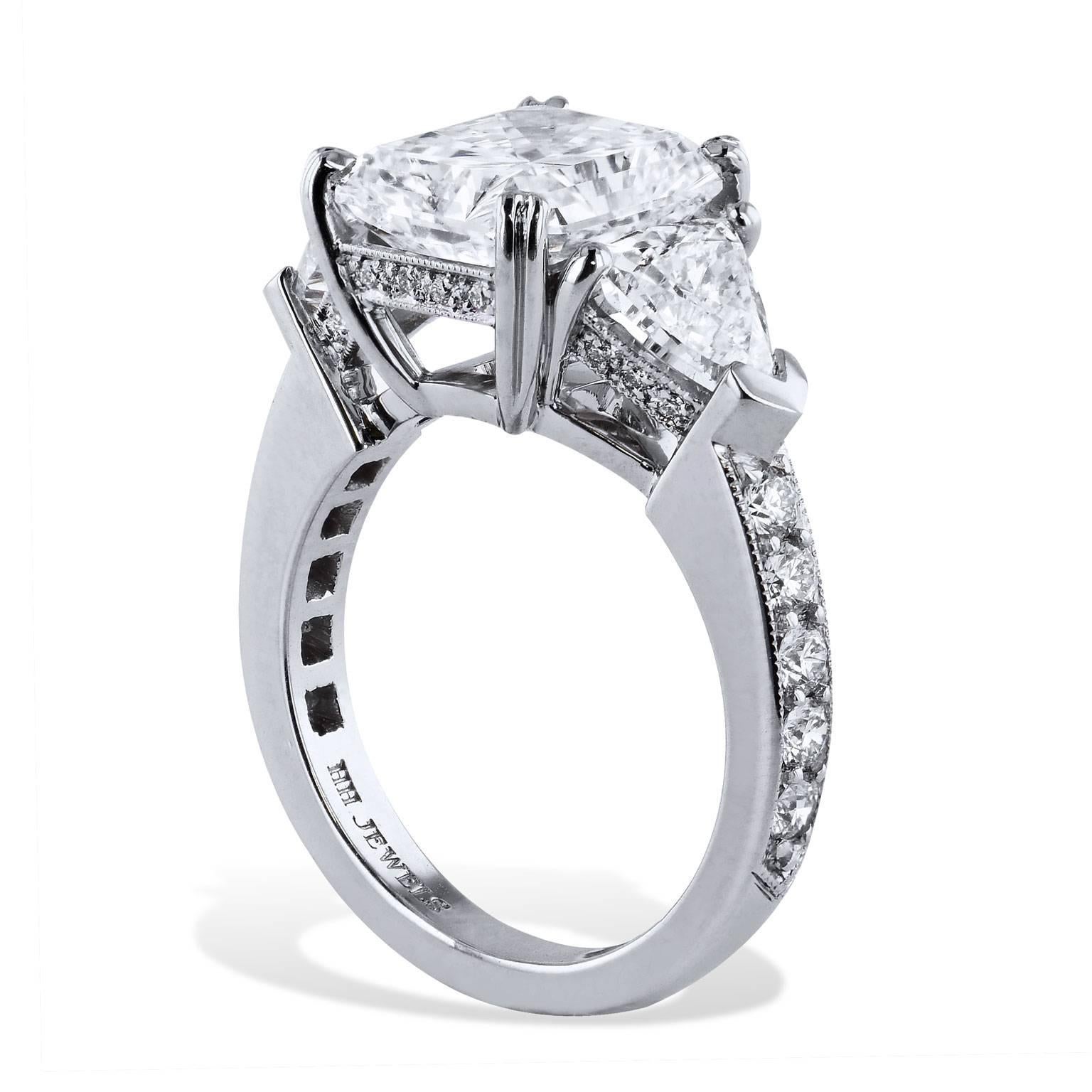 An engagement ring that will warm her heart and leave her speechless. Handmade by H, this ring features a bold 4.33 carat cut-cornered rectangular mixed cut diamond set at center and is fashioned in platinum (G/SI1; GIA #13810927). Two pieces of