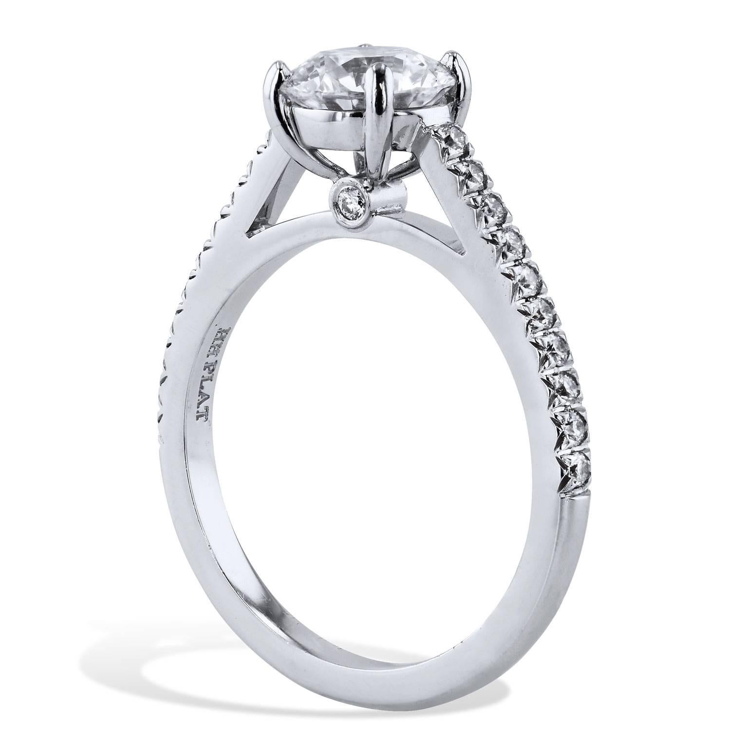 This breathtaking handmade platinum engagement ring by H features a 1.29 carat GIA certified round brilliant cut, prong-set diamond graded E/VS1 at center (GIA#11169977). Accentuated by 0.25 carat of pave-set diamond (G/H/VS) down the shank,