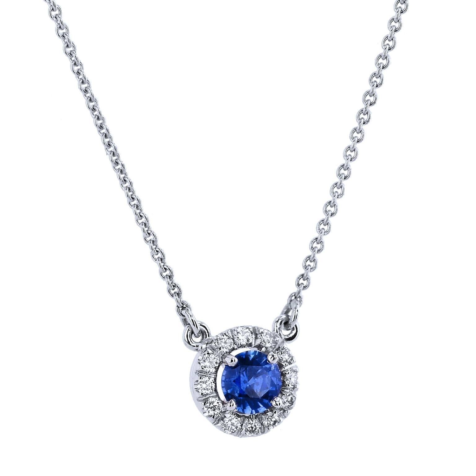 Let the sapphire’s tranquil blue hue sweep you away in this handcrafted 18 karat white gold pendant necklace. A 0.45 carat royal blue sapphire is set at center and embraced by 0.12 carat of pave set diamond in halo (H/VS). Strung on an 18 kart white