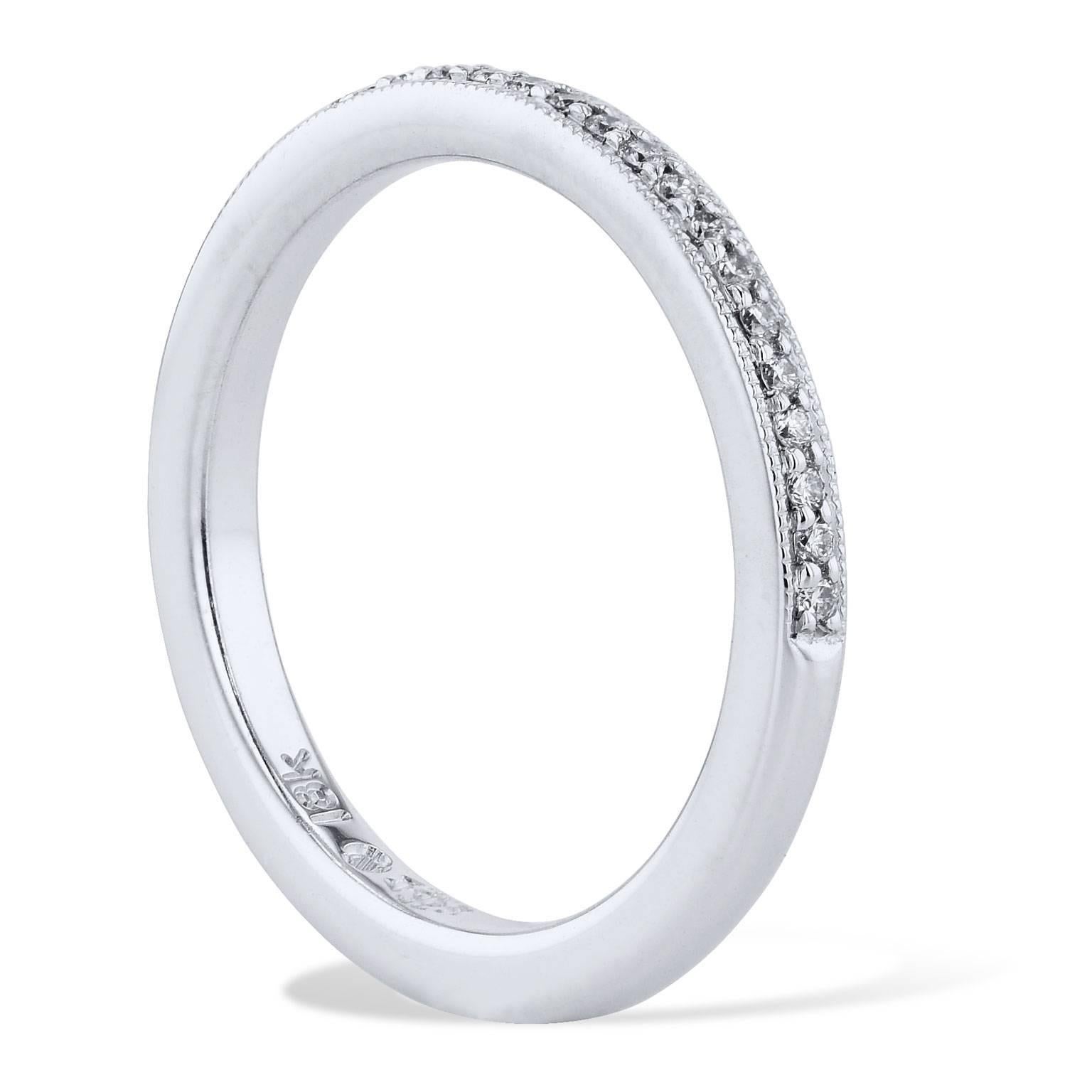 Imagine twenty-seven pave-set round brilliant cut diamonds encircling your finger in this handmade 18 karat white gold band ring. This charming half-diamond band features a total weight of 0.12 carat with milgrain work (G/H/VS2/SI1).