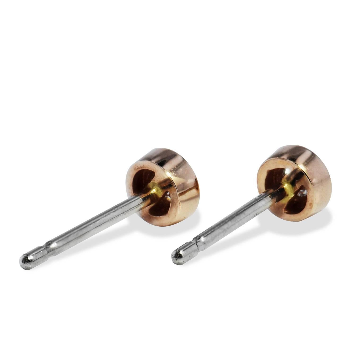 The perfect accessory to complete your sleek and stylish look. These handmade H and H 14 karat rose gold round brilliant cut diamond stud earrings are just charming. Two diamonds with a total weight of 0.14 carat are bezel set and are F/G in color