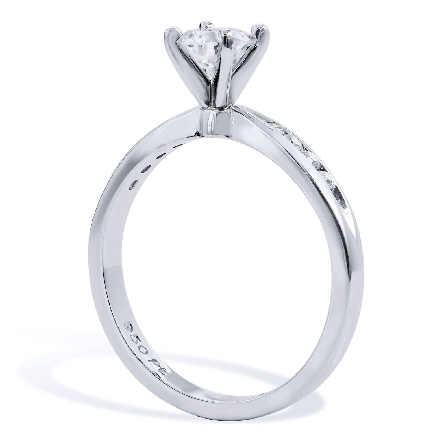 Enjoy this previously loved platinum engagement ring  featuring  a stunning 0.46 carat round diamond set at center, graded H/VS2. Complemented by an additional 0.16 carat of pave set diamonds sweeping the reverse tapered shank (H/I/SI); this is a