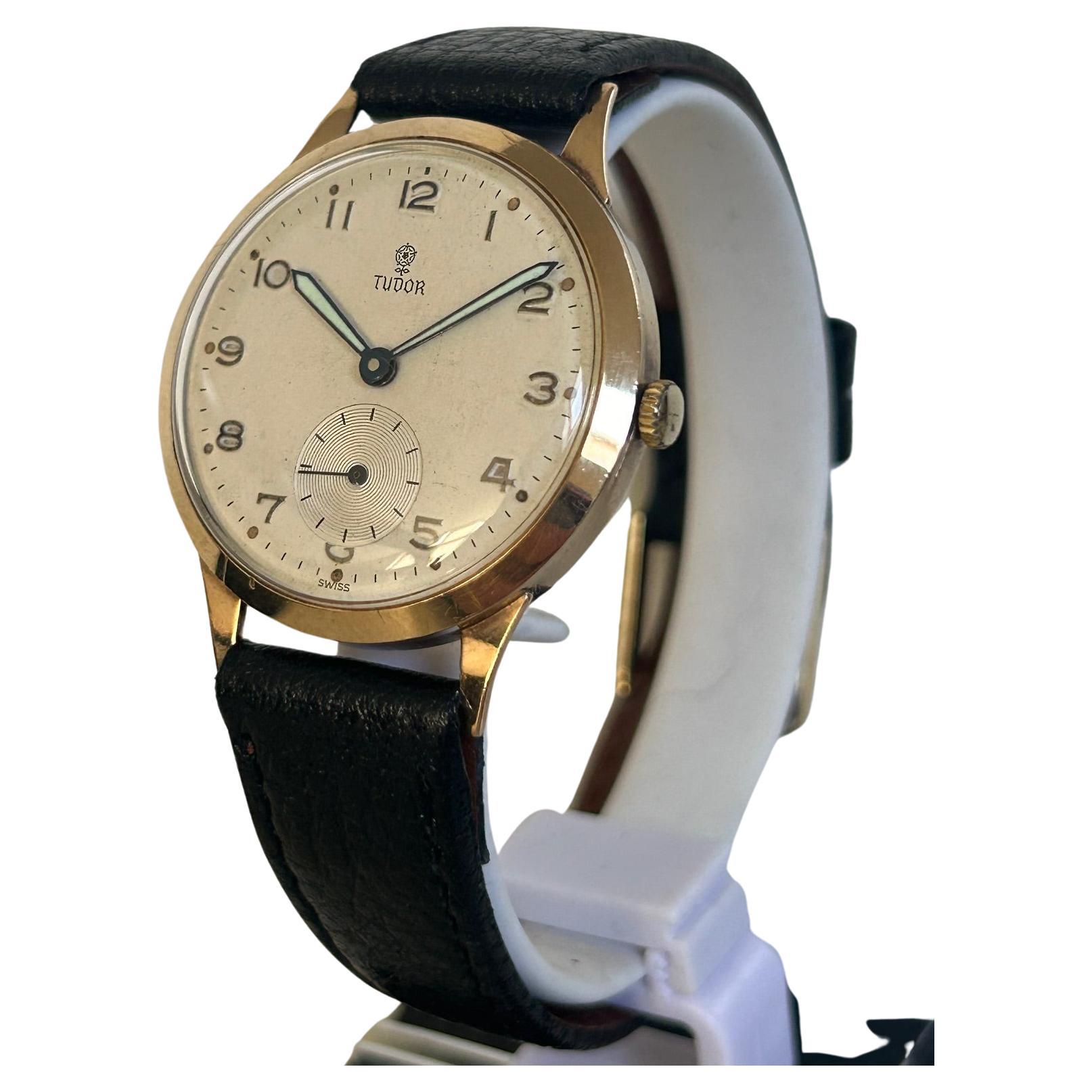 Our vintage and very attractive, manual wind, round 9k yellow gold cased Tudor, with sub seconds dial and ivory coloured arabic numeral dial, is presented in excellent condition given its age. The case measures 33mm with crown (32mm without) and