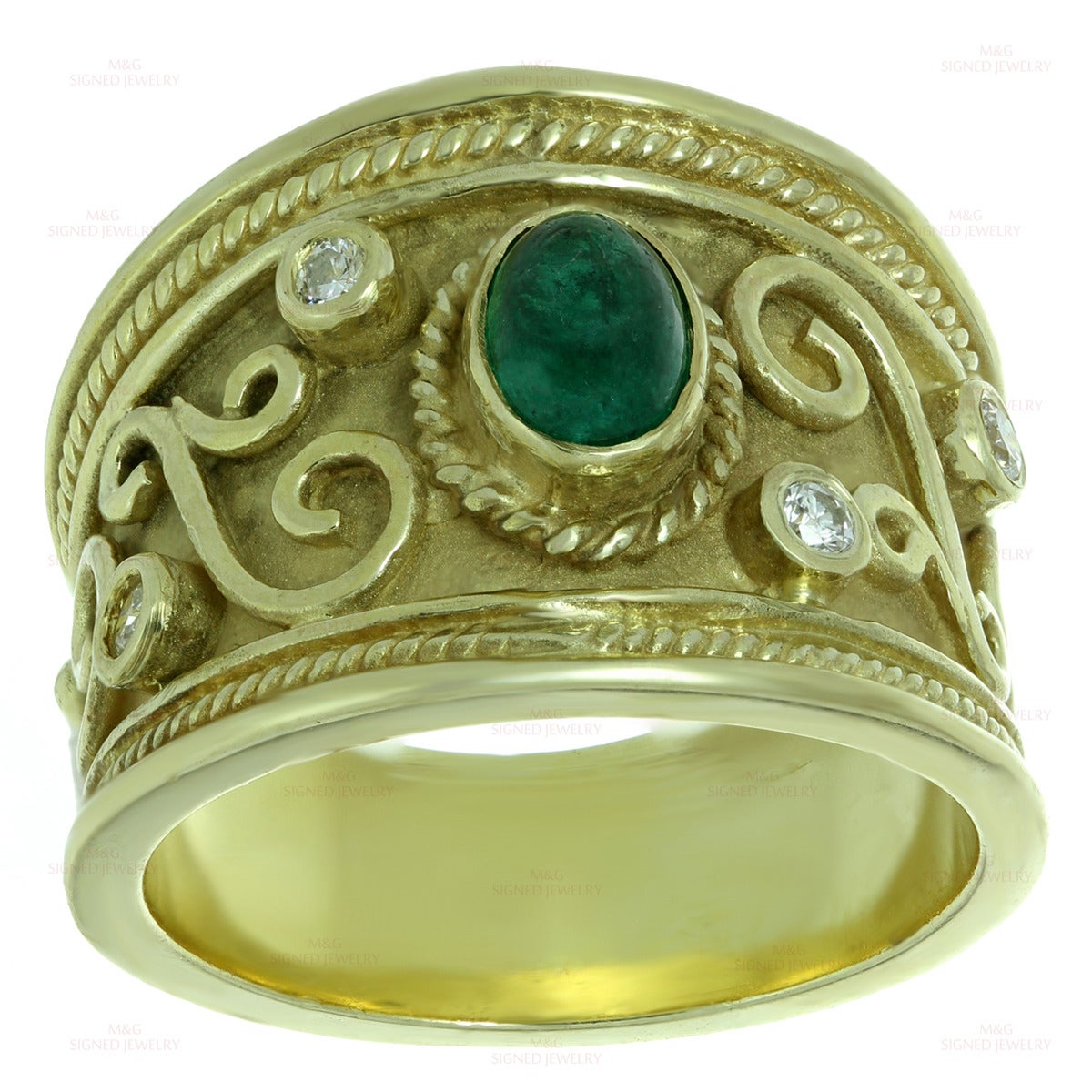 This elegant Byzantine-era inspired wide band is made in 14k yellow gold and bezel-set with a 4.0mm x 6.0mm oval cabochon emerald stone of an estimated 0.60 carats and 4 round brilliant-cut H-I VS1-VS2 diamonds of an estimated 0.16 carats. Made in