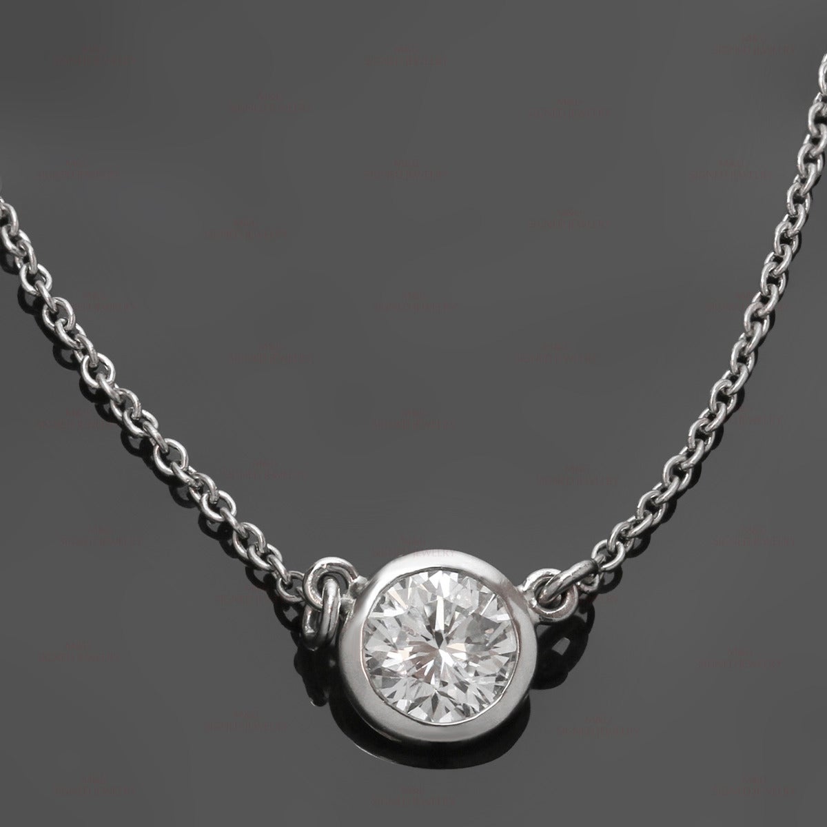 This fine platinum Tiffany & Co. necklace was designed by Elsa Peretti and features a small round pendant bezel-set with a brilliant-cut E-F VVS2-VS1 diamond of an estimated 0.60 carats. Made in United States circa 2000s. Measurements: 0.23