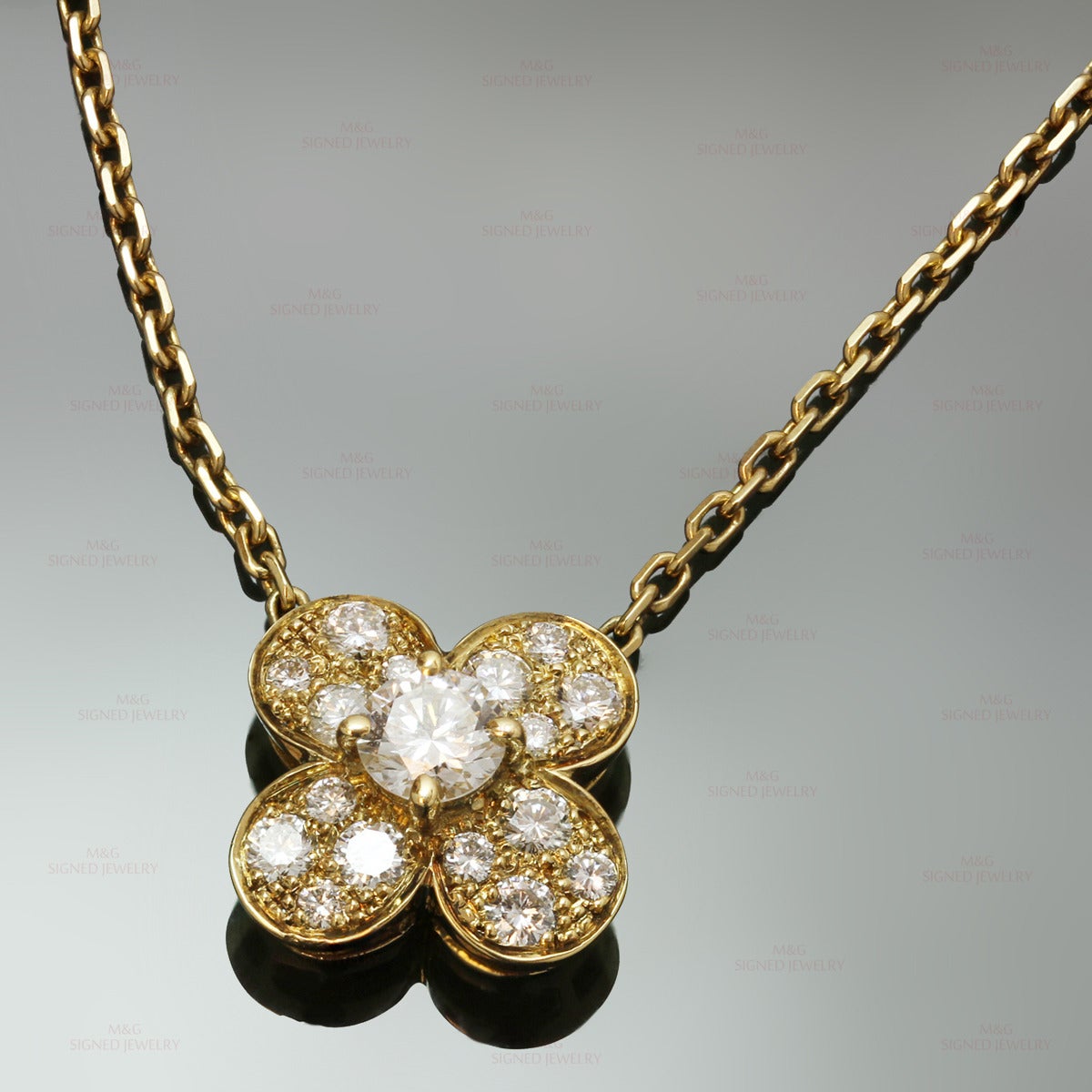 This stunning Van Cleef & Arpels necklace from the classic Alhambra collection is crafted in 18k yellow gold and features a luckly clover pendant set with brilliant-cut round E-F VVS2-VS1 diamonds of an estimated 0.50 carats. Made in France circa