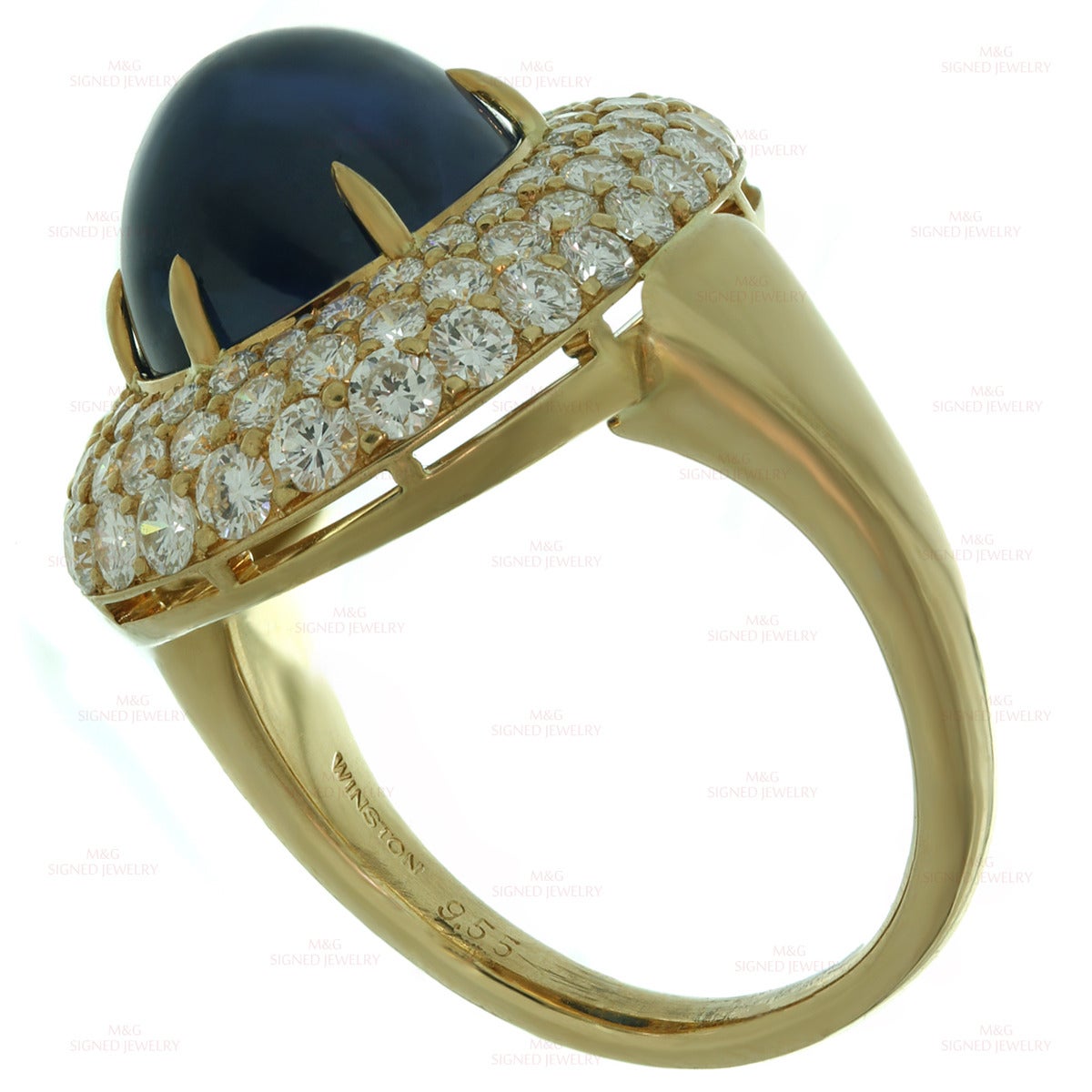 This exquisite Harry Winston ring is made in 18k yellow gold and set with a stunningly vivid blue oval cabochon sapphire of an estimated 9.55 carats surrounded by brilliant-cut round F-G VVS2-VS1 diamonds of an estimated 2.7 carats. Made in United