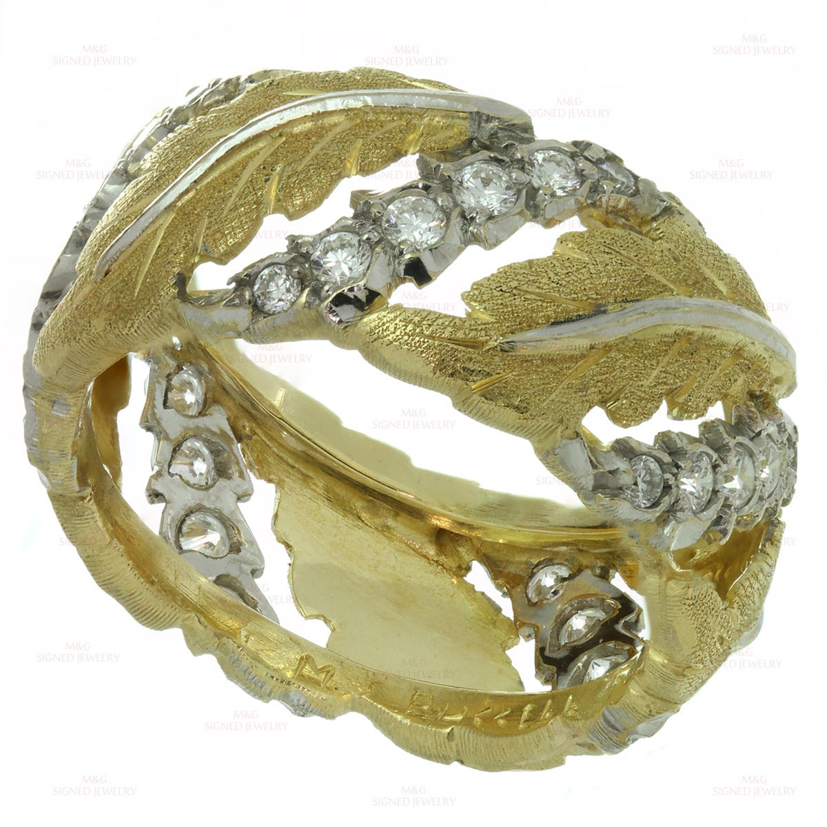 This elegant Mario Buccellati band ring features a leaf design crafted in 18k yellow gold and accented with sparkling brilliant-cut round F-G VVS2-VS1 diamonds of an estimated 0.90 carats set in 18k white gold. Made in Italy circa 1990s.