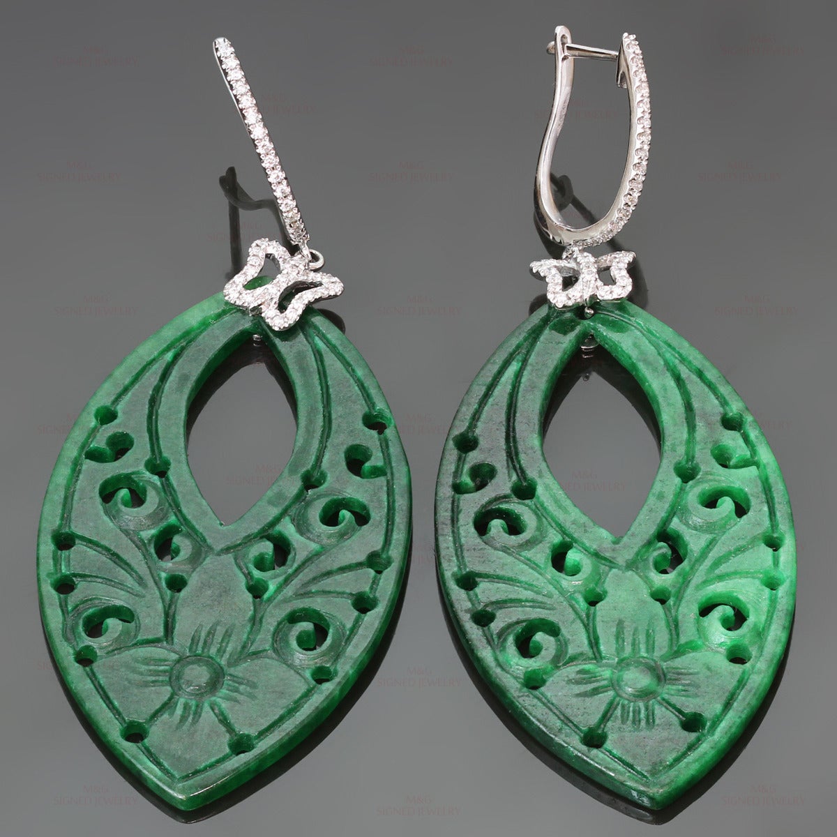These fabulous 18k white gold pendant earrings feature beautifully carved green jade drops accented with sparkling butterflies set with 76 G-H VS1-VS2 diamonds of an estimated 0.55 carats. Jade has not been checked for treatment. Measurements: 1.06