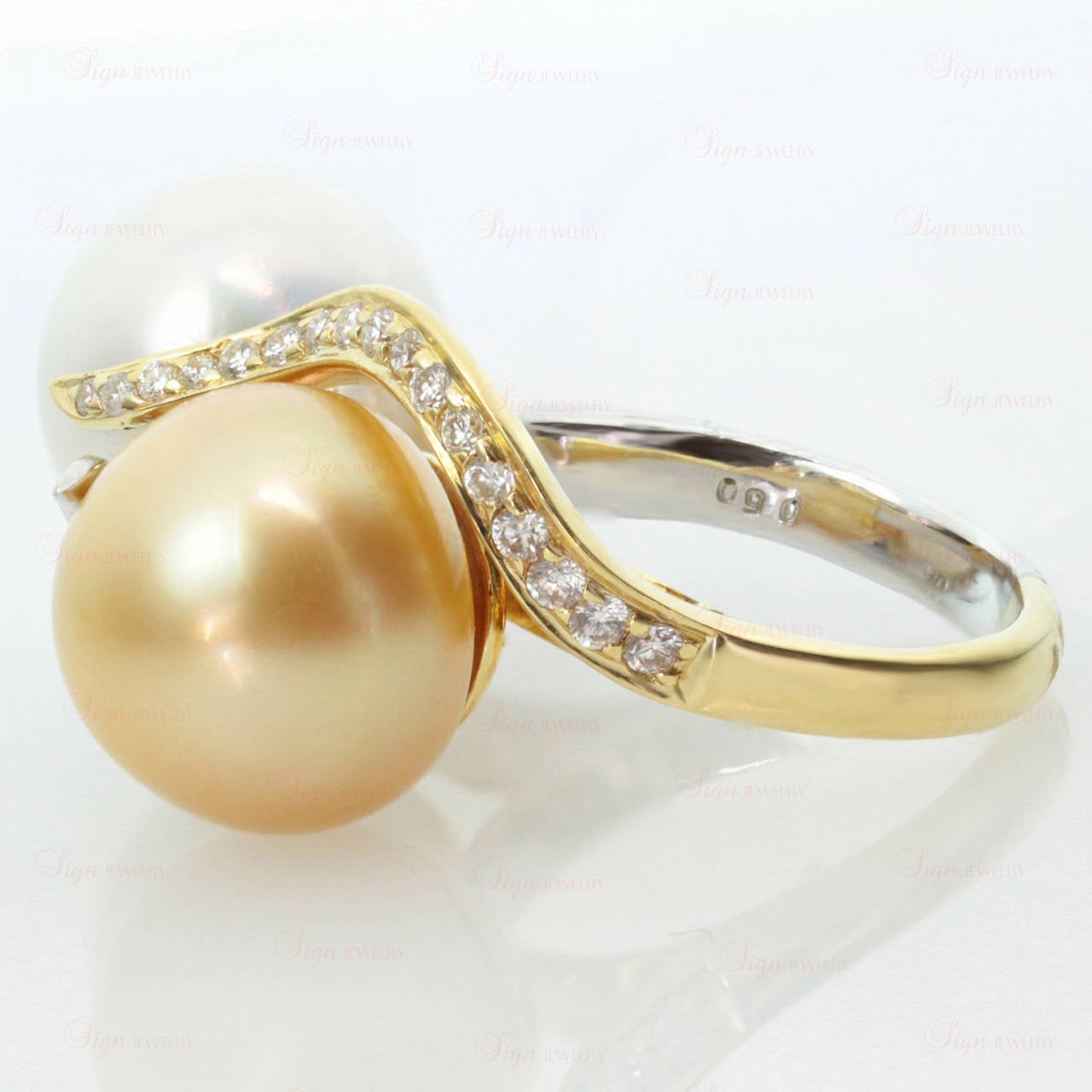 This modern woman's ring features an elegant design of dual unity expressed in the two tones of 18k yellow & white gold and a pair of natural 13.0mm South Sea cultured pearls - a vivid fancy yellow pearl and a pure white pearl. Both pearls are