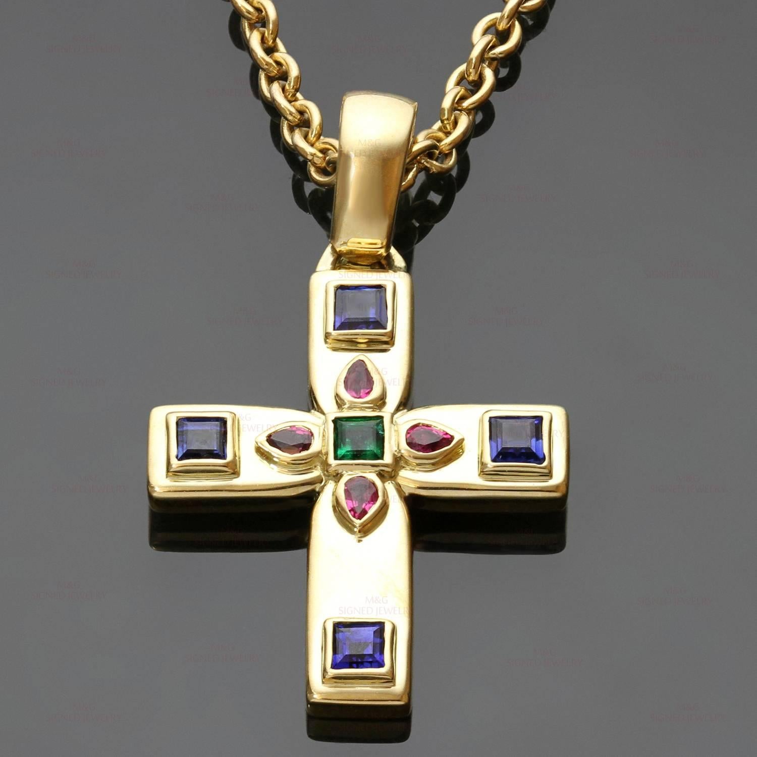 This magnificent Cartier enhancer cross pendant necklace is crafted in 18k yellow gold and set with faceted rubies, sapphires, and emerald. The Byzantine motif was designed by Louis Cartier during his trip to Russia in the early part of the 20th