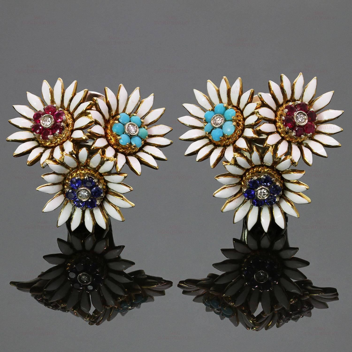 These vibrant retro clip-on earrings feature clusters of blossoming flowers with white enamel petals crafted in 18k yellow gold and set with 12 round cabochon turquoises, 12 mixed-cut round sapphires, 12 mixed-cut round rubies and 6 brilliant-cut
