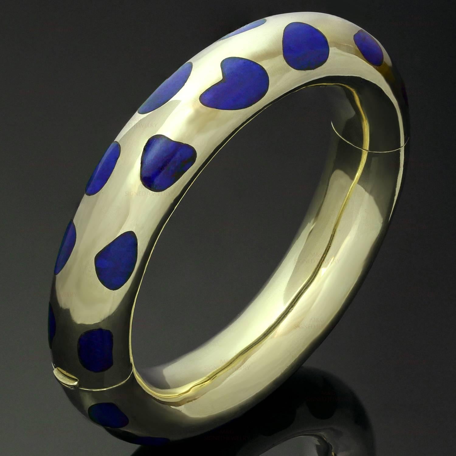 This fabulous Tiffany & Co. bracelet designed by Angela Cummings is crafted in 18k yellow gold and features chic fluid shapes inlaid with lapis lazuli. This bangle was made in United States circa 1980s. Measurements: 0.59" (15mm) width,