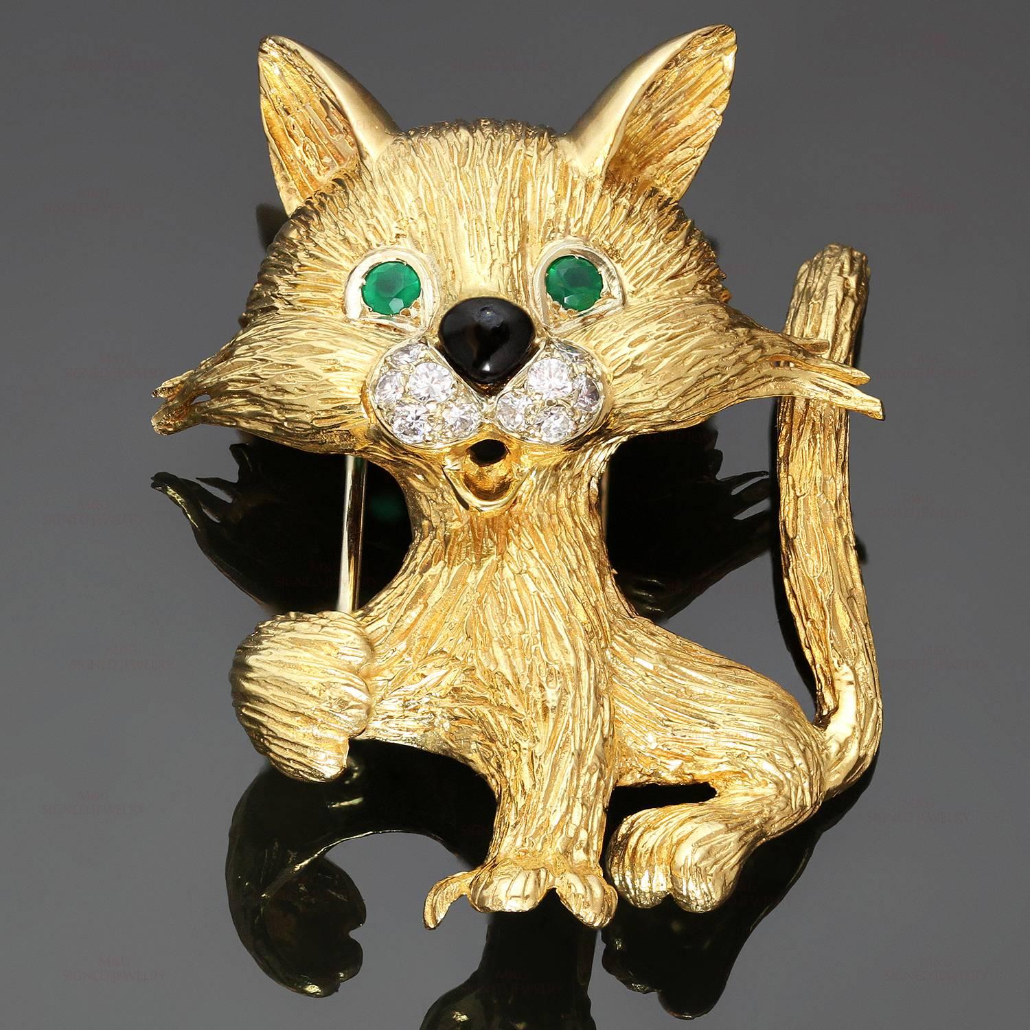 This rare Van Cleef & Arpels brooch features a mid-century design of a whimsical cat crafted in 18k yellow gold and accented with 10 round brilliant-cut diamonds of an estimated 0.27 carats, 2 round-cut emerald eyes of an estimated 0.10 carats, and